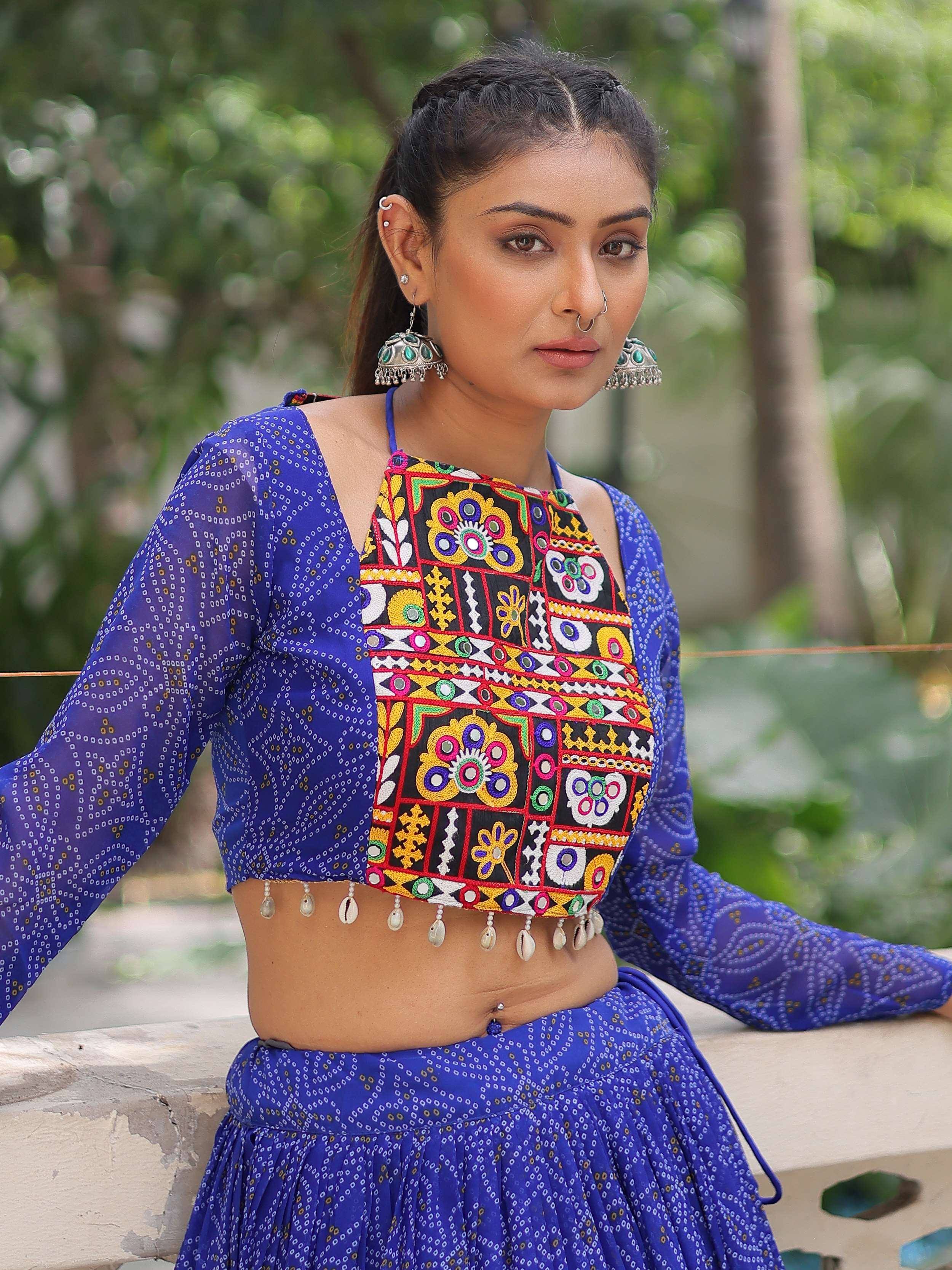 Blue ethnic crop top with colorful mirror work and shell tassels, paired with matching skirt