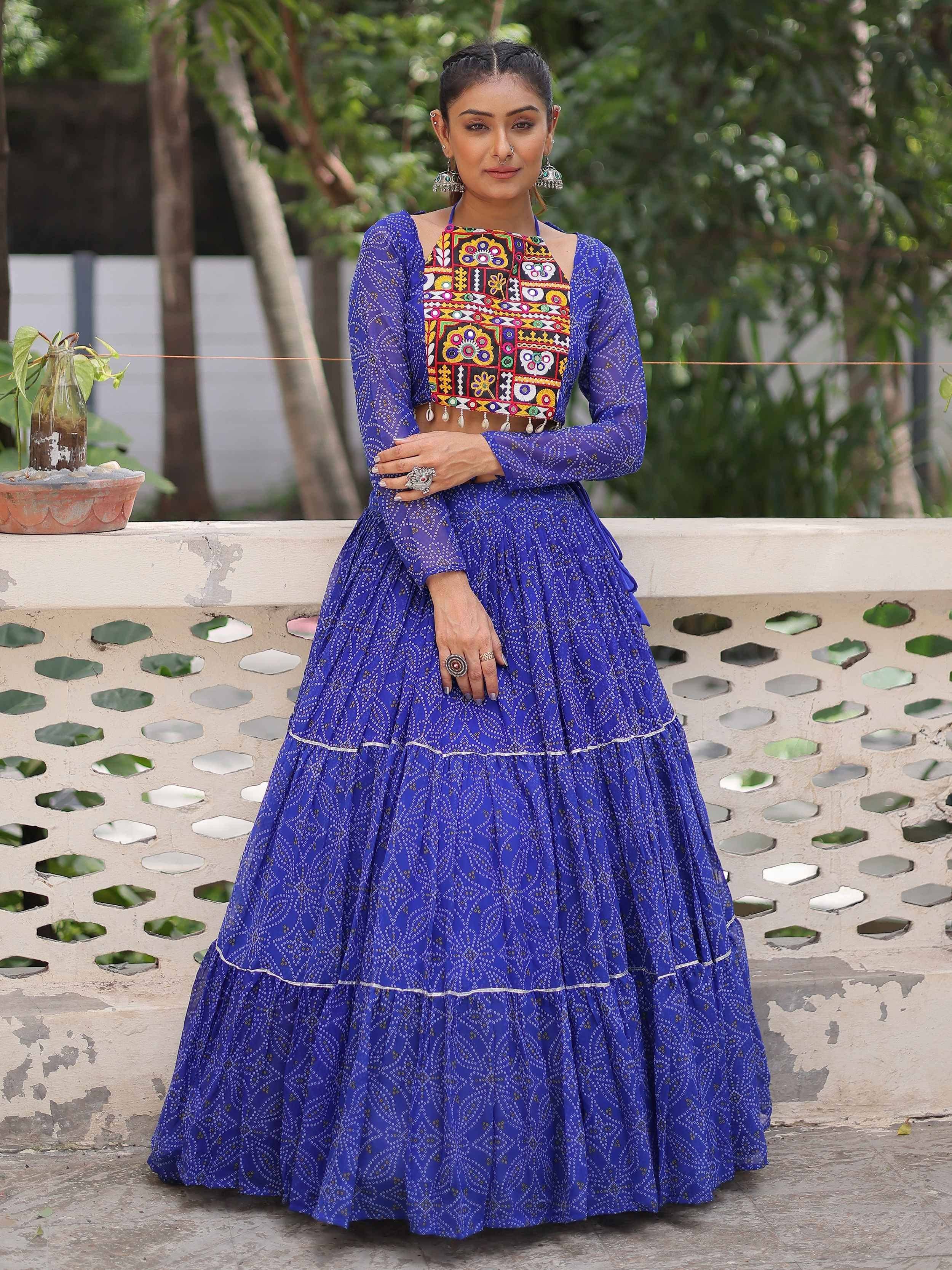 Royal blue printed lehenga with colorful embroidered crop top, perfect for Indian ethnic wear occasions.