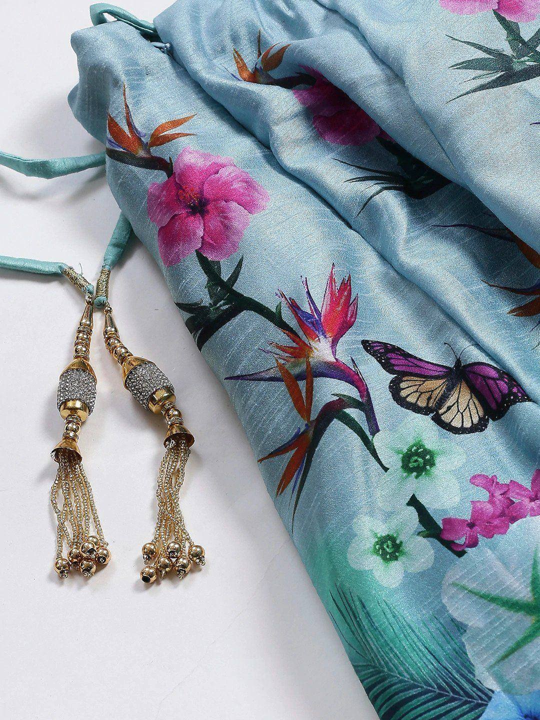 Light blue floral saree with butterfly print and gold tassels, ideal for ethnic wear occasions