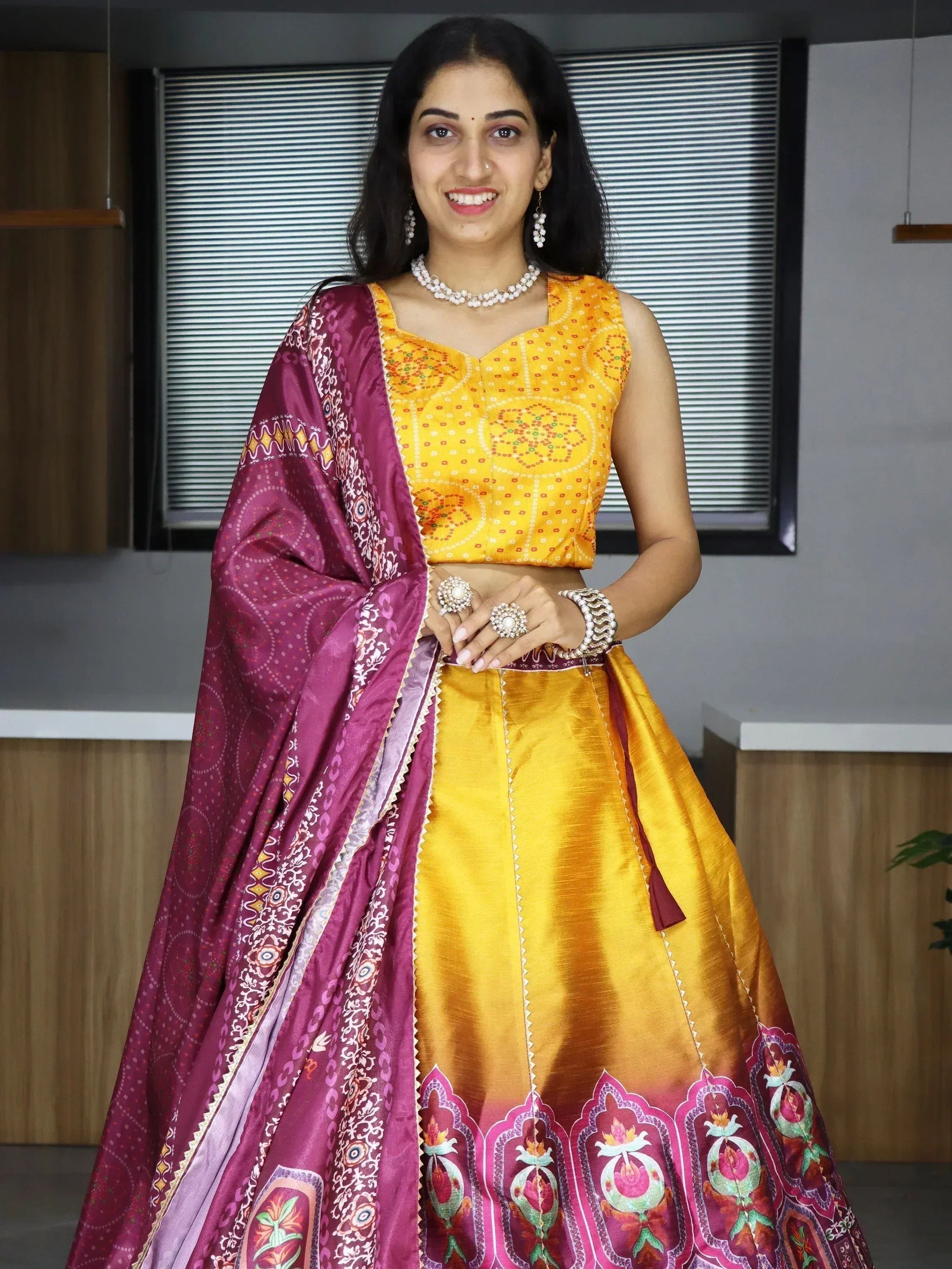 Yellow and maroon printed lehenga choli with floral border, perfect for Indian ethnic wear occasions