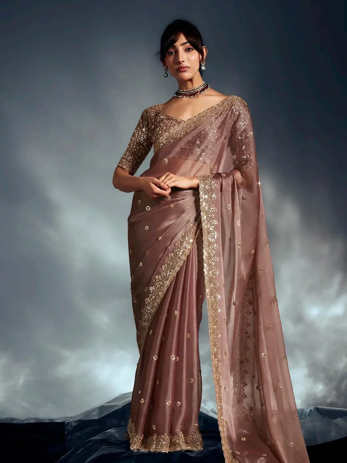Elegant mauve saree with gold embroidery and sequins, perfect for Indian ethnic wear occasions.