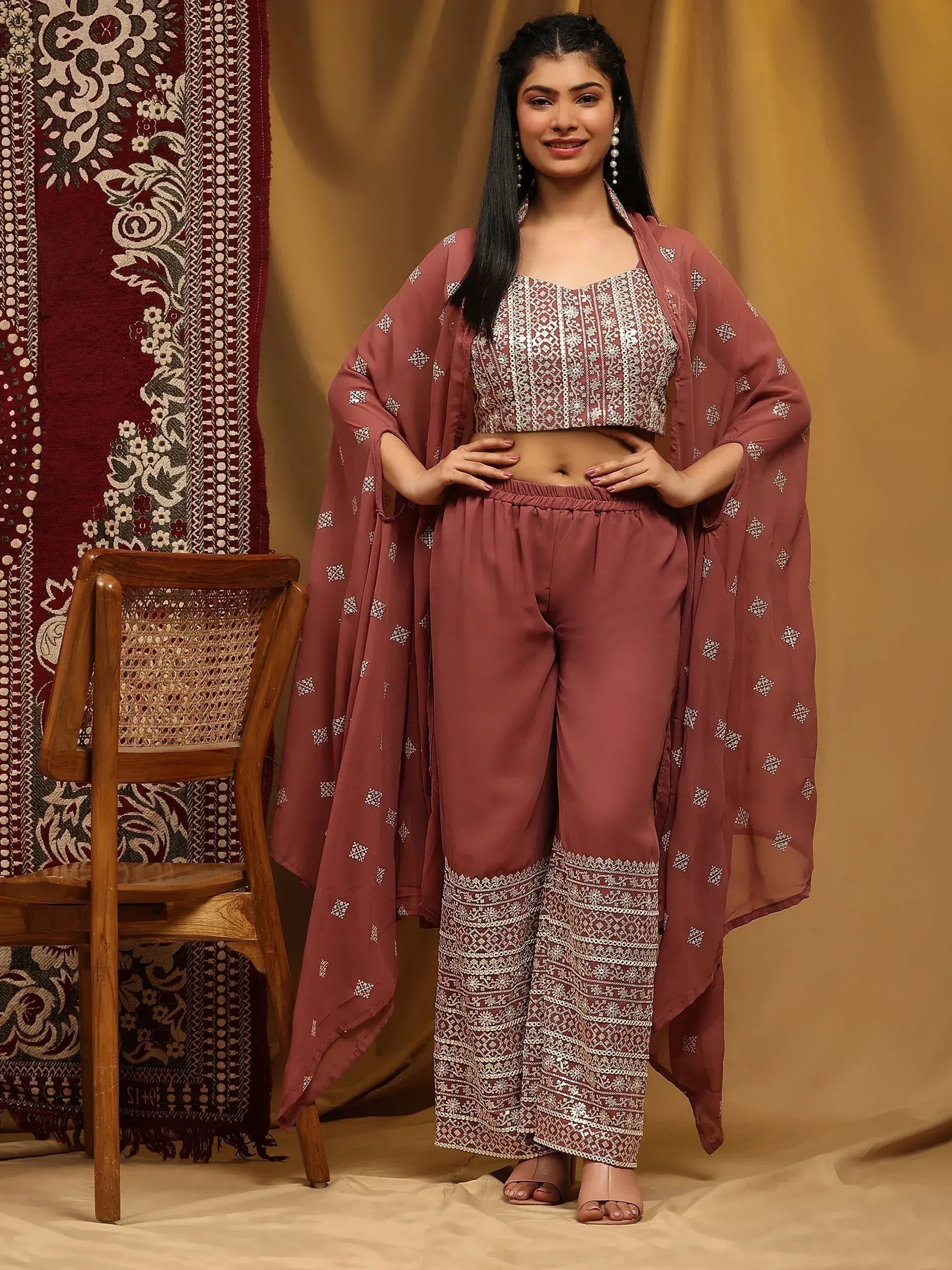 Woman in mauve ethnic palazzo set with embroidered crop top, cape, and printed dupatta
