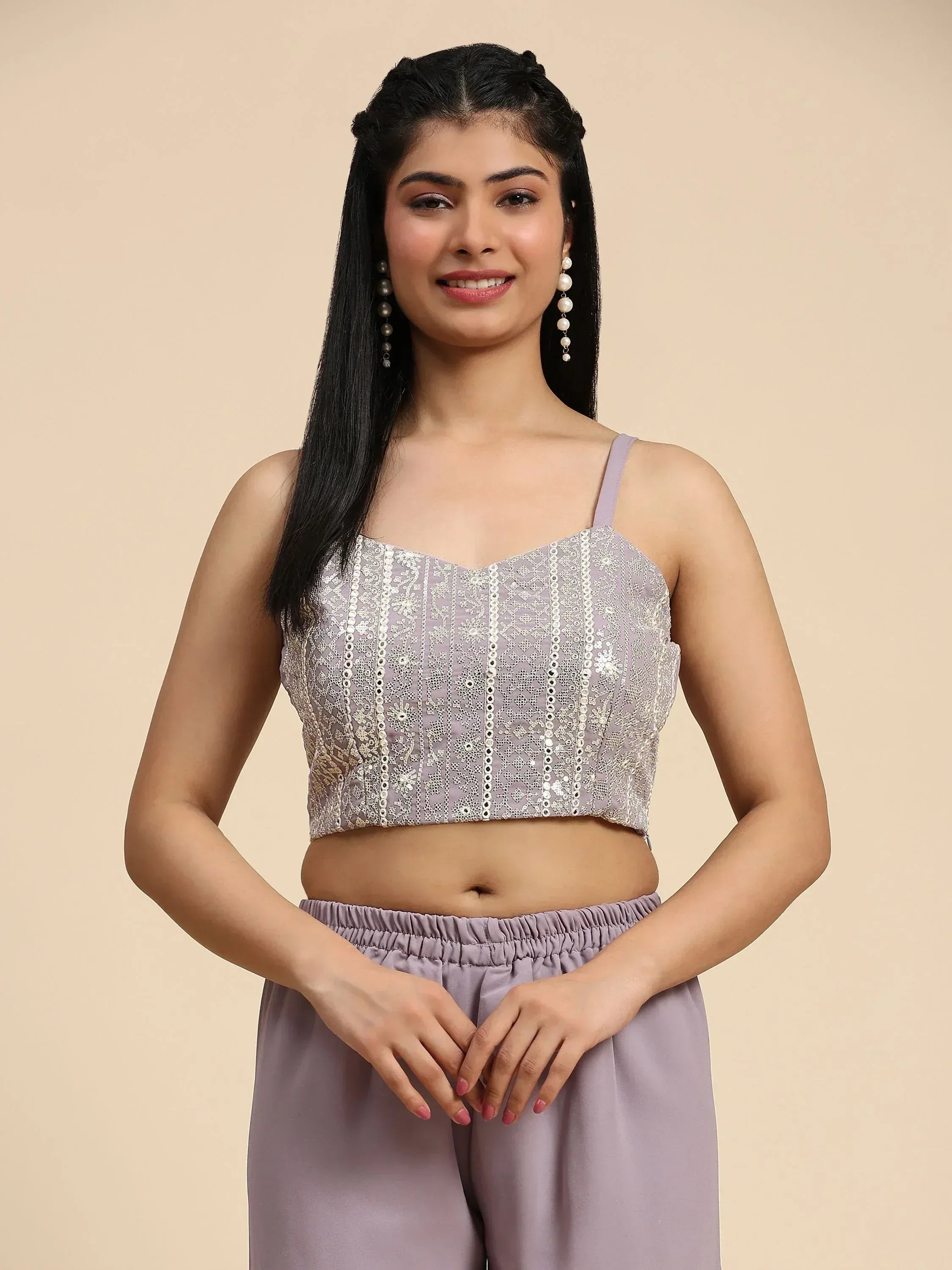 Woman wearing lavender embroidered ethnic crop top with spaghetti straps and matching pants