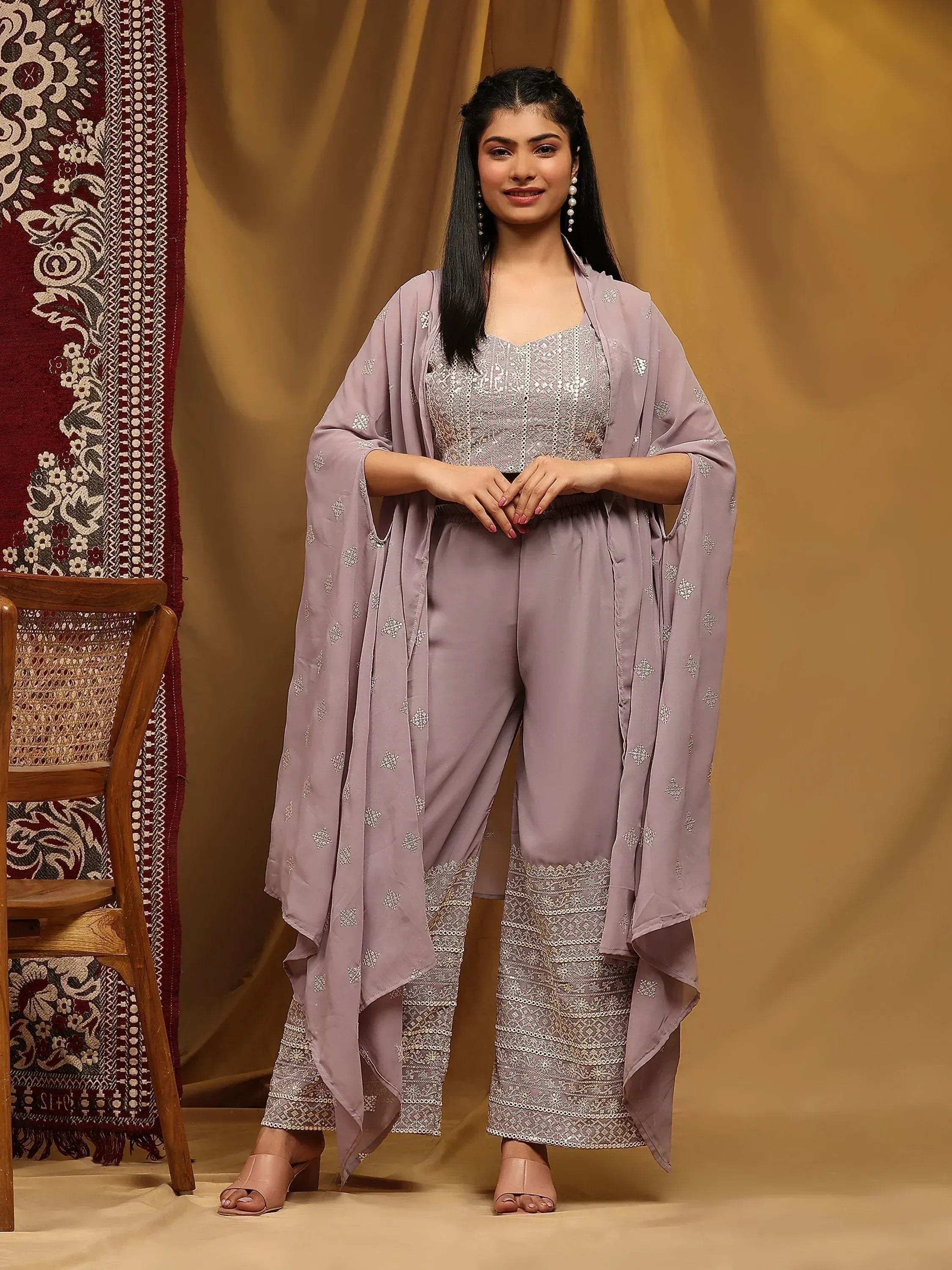 Woman wearing a mauve embroidered ethnic jumpsuit set with dupatta, traditional Indian attire