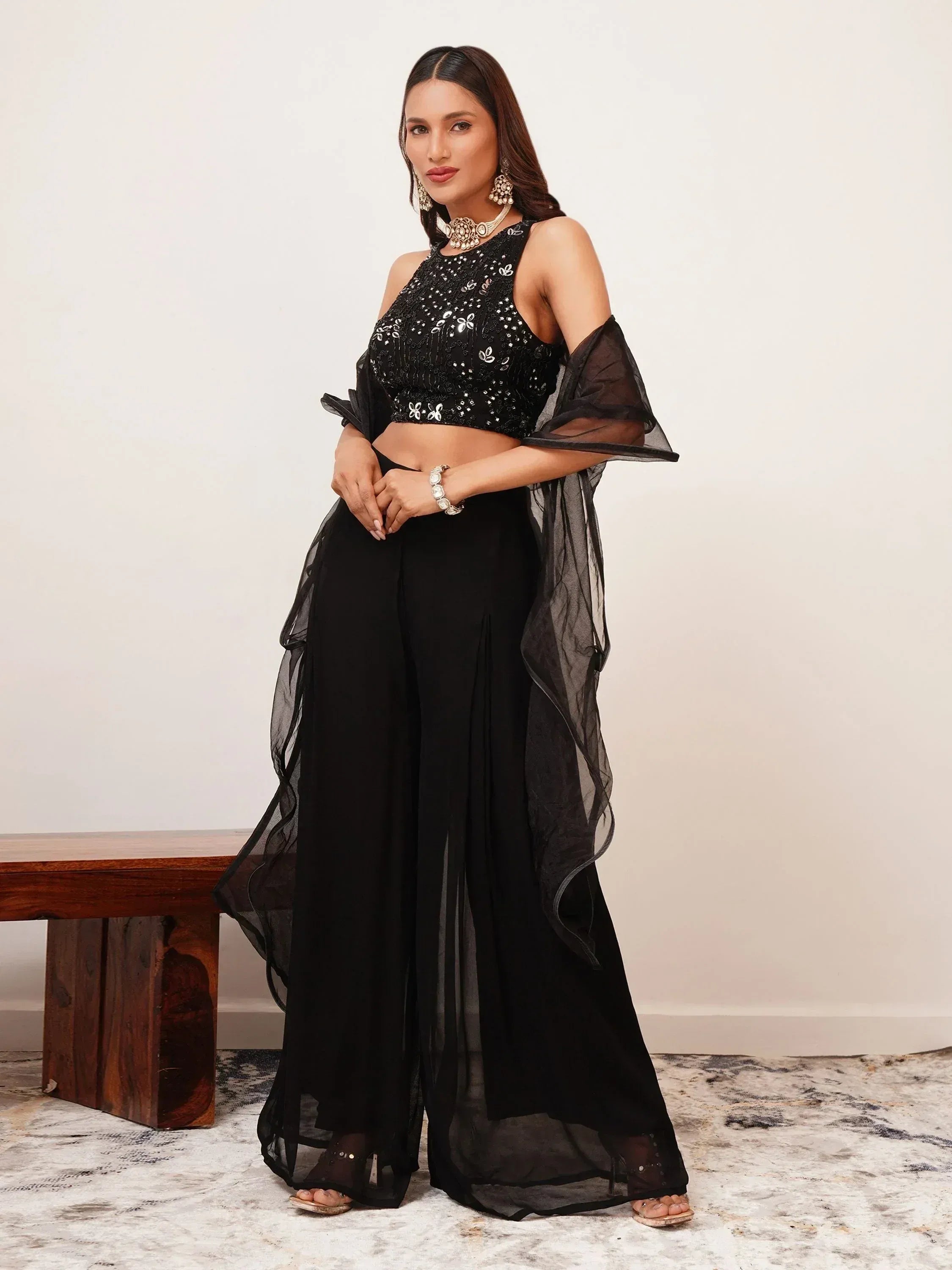 Woman in black sequin ethnic crop top and palazzo pants set with dupatta, posing indoors