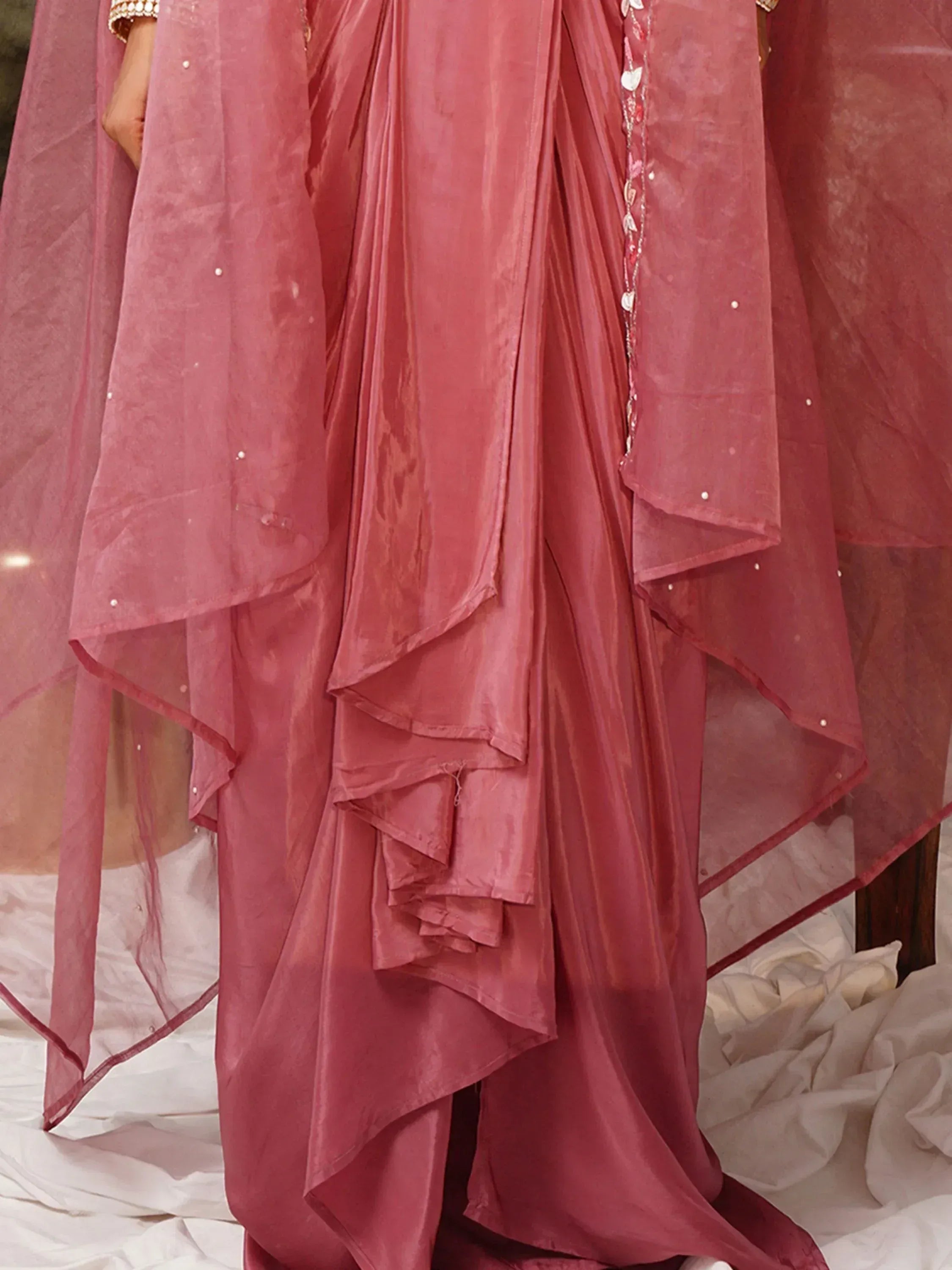 Dusty rose ethnic gown with layered ruffles and pearl embellishments, perfect for Indian celebrations