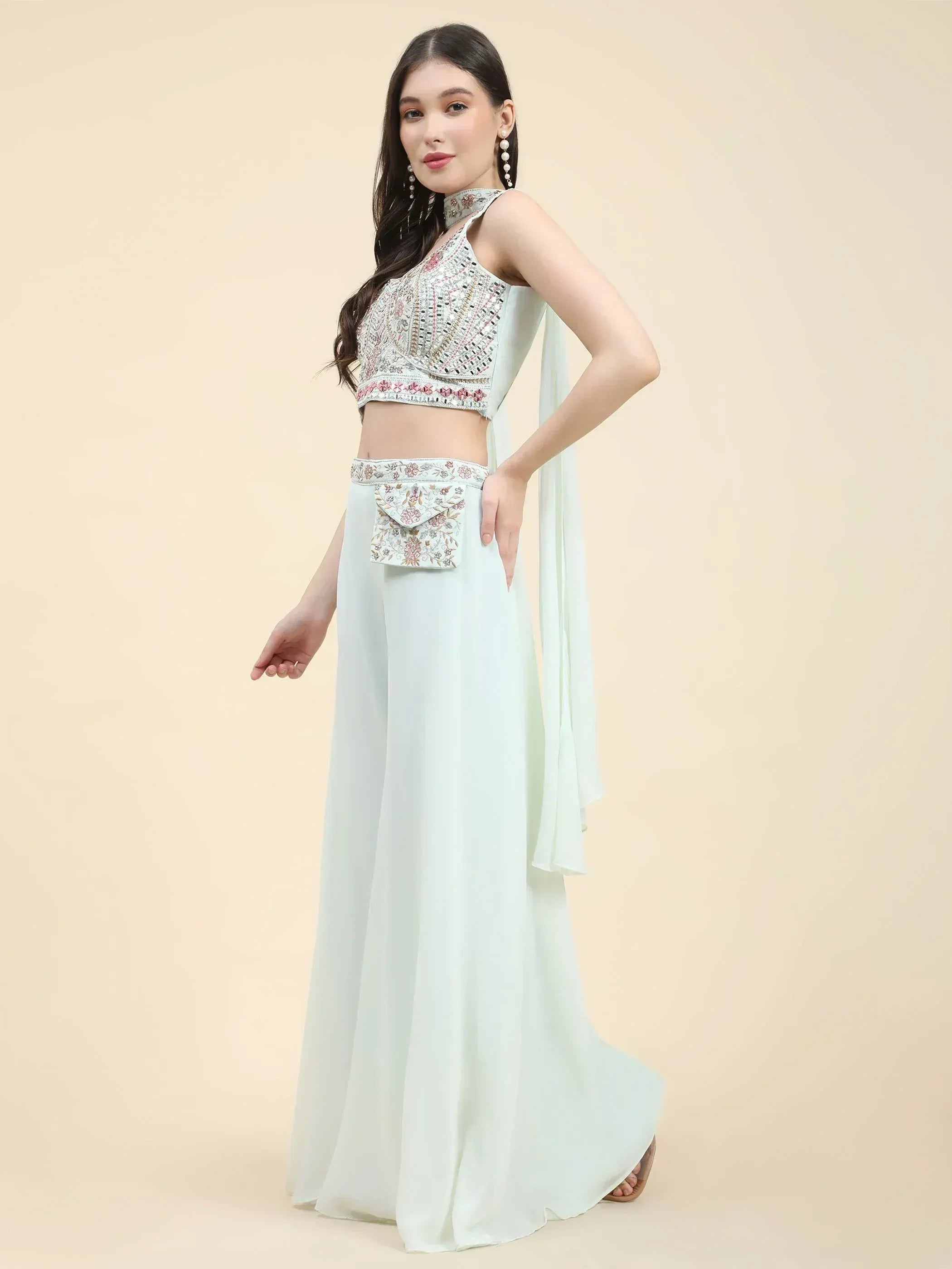 Woman wearing pastel green embroidered ethnic crop top and palazzo pants set