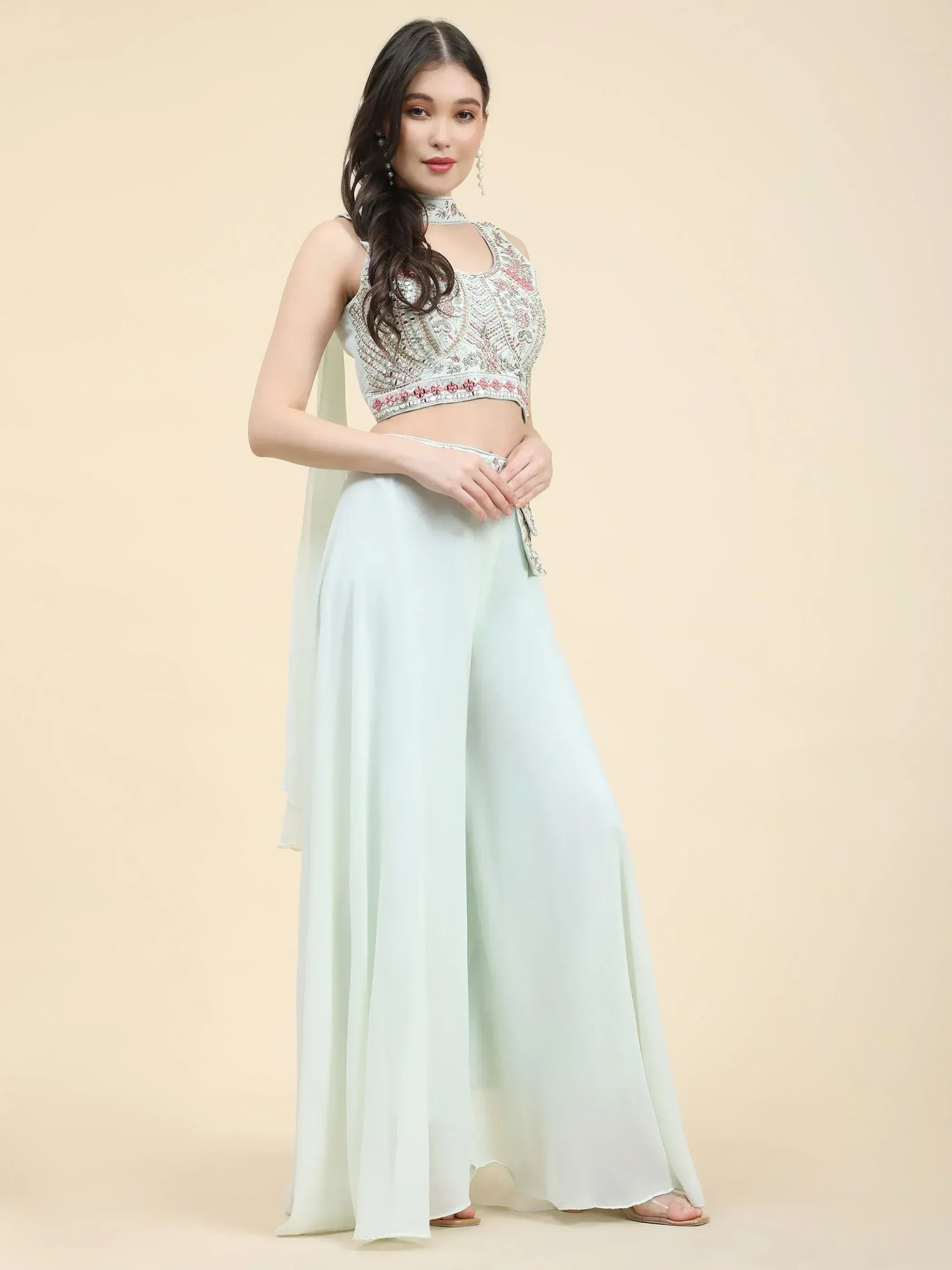 Woman wearing mint green embroidered ethnic crop top with wide leg palazzo pants