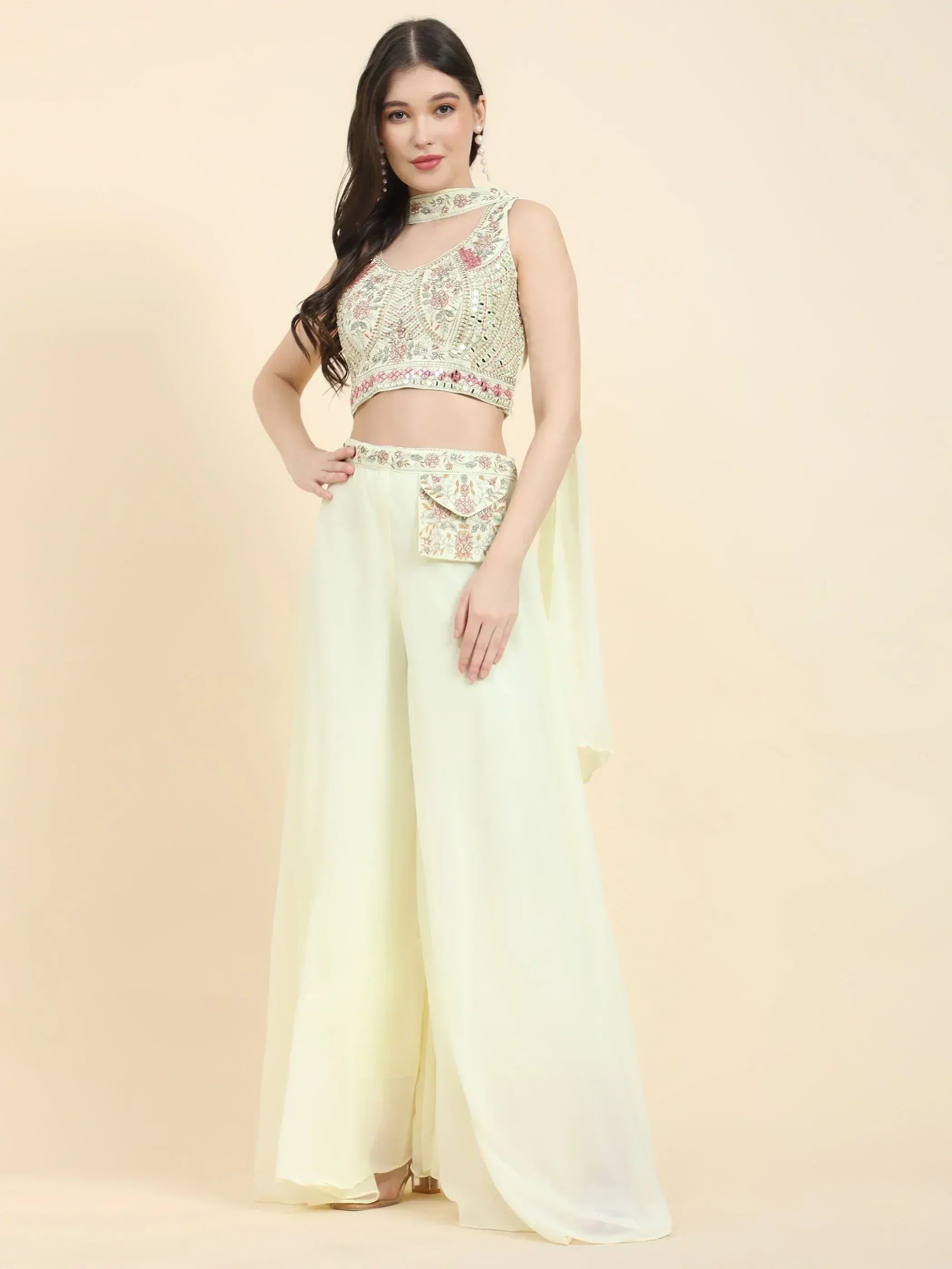 Woman in pastel embroidered crop top with wide-leg palazzo pants, Indian ethnic wear