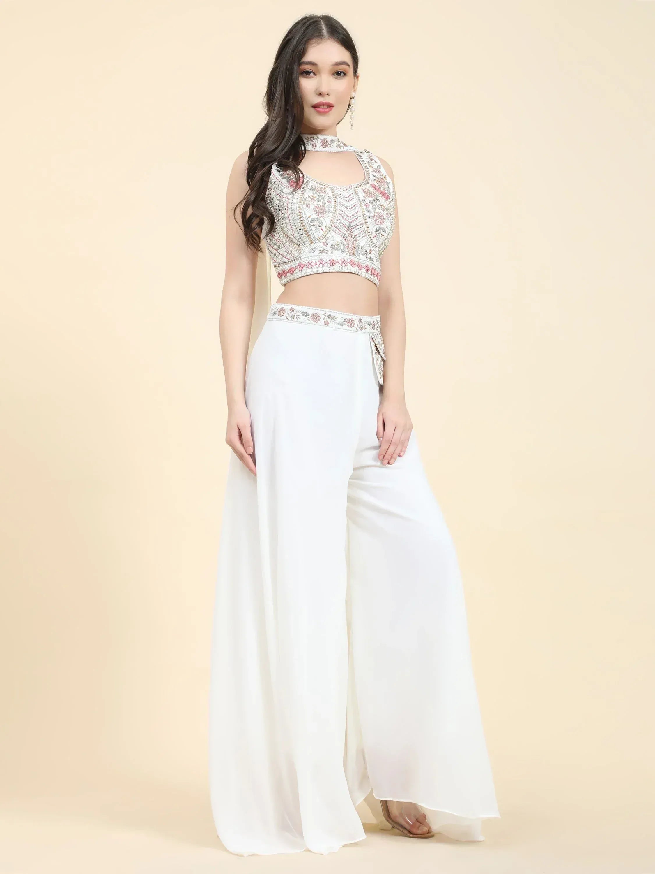 Woman wearing white Indian ethnic crop top and palazzo set with intricate embroidery