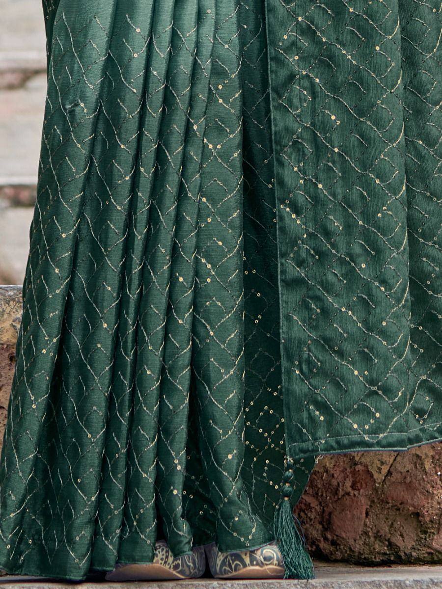 Emerald green ethnic gown with gold thread embroidery and tassel detail, perfect for festive occasions.