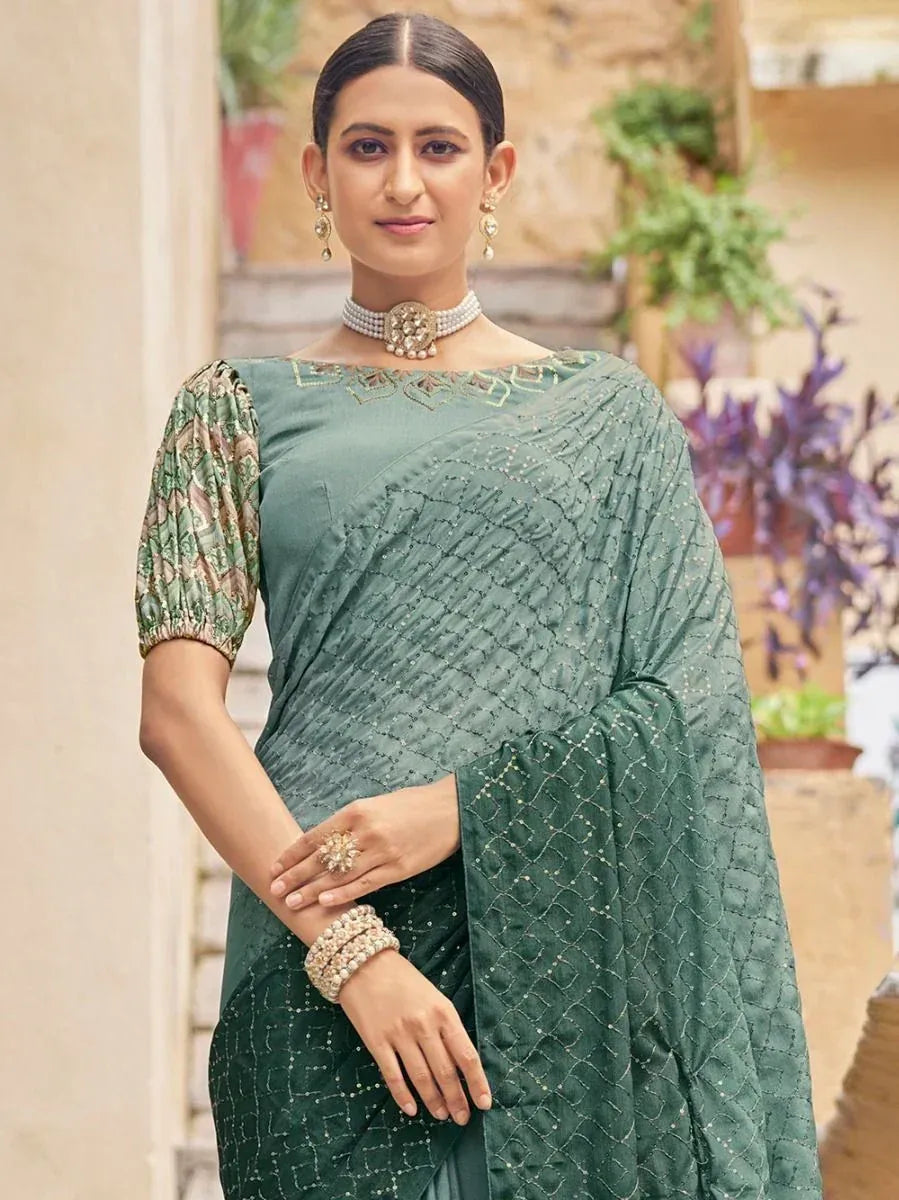 Elegant green saree with embroidered blouse and pearl jewelry, perfect for Indian ethnic occasions