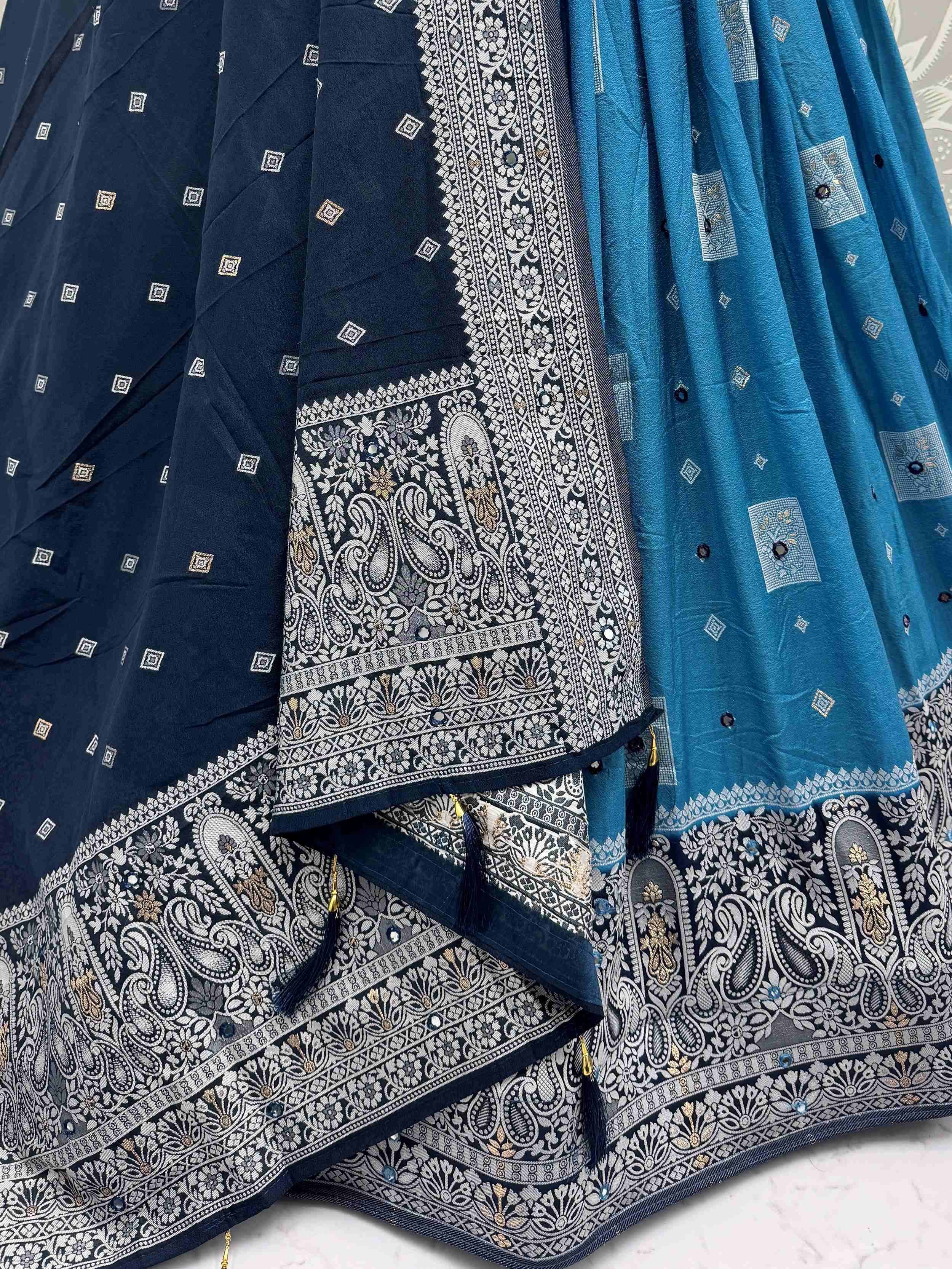 Navy and teal ethnic lehenga choli with intricate paisley embroidery and mirror work details