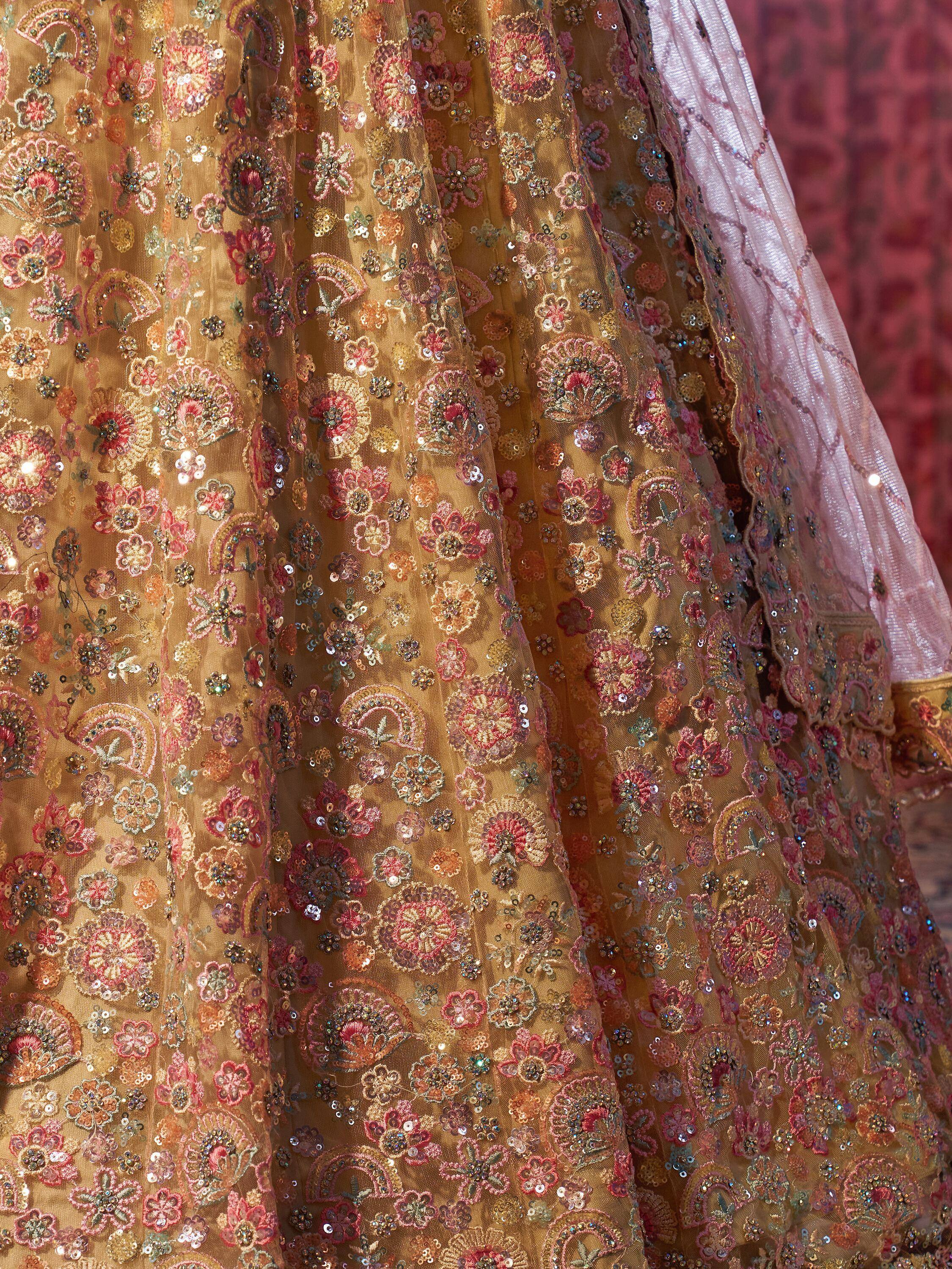 Golden floral embroidered lehenga with pink dupatta, perfect for Indian ethnic wear and festive occasions.