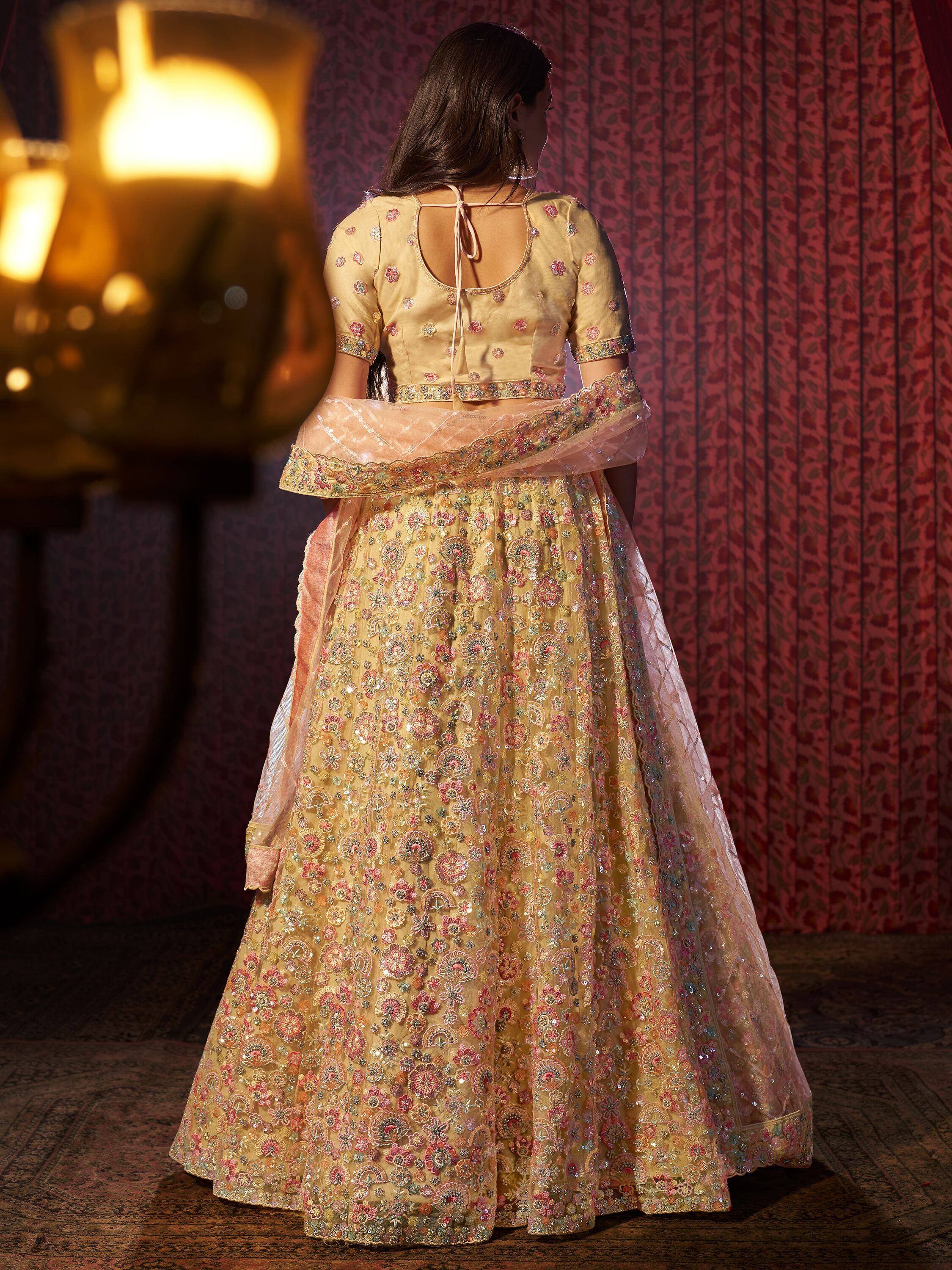 Elegant yellow lehenga choli with floral embroidery and sequins, perfect for Indian ethnic occasions.