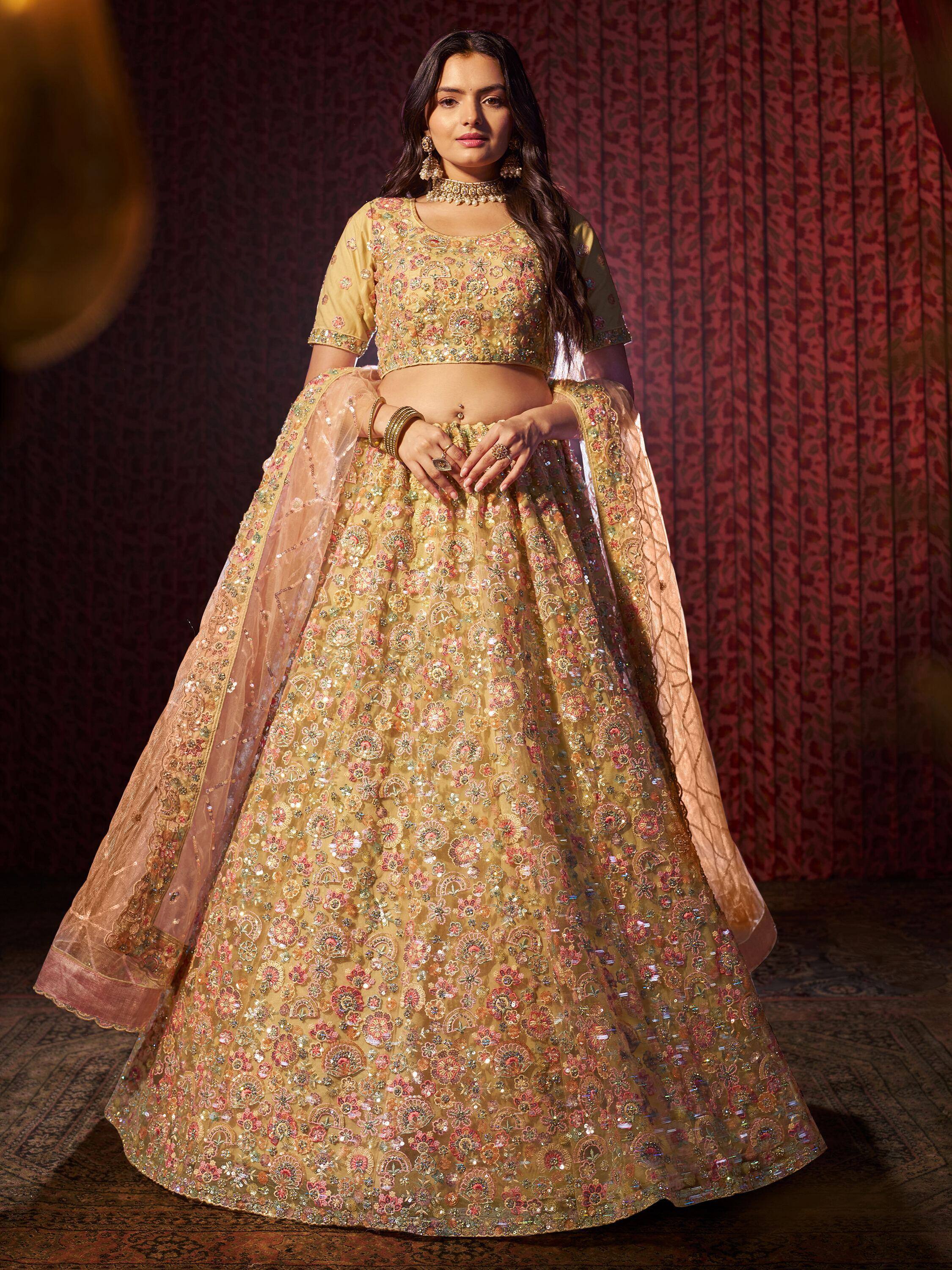 Elegant gold lehenga choli with floral embroidery and sequins, perfect for Indian weddings and festive occasions.