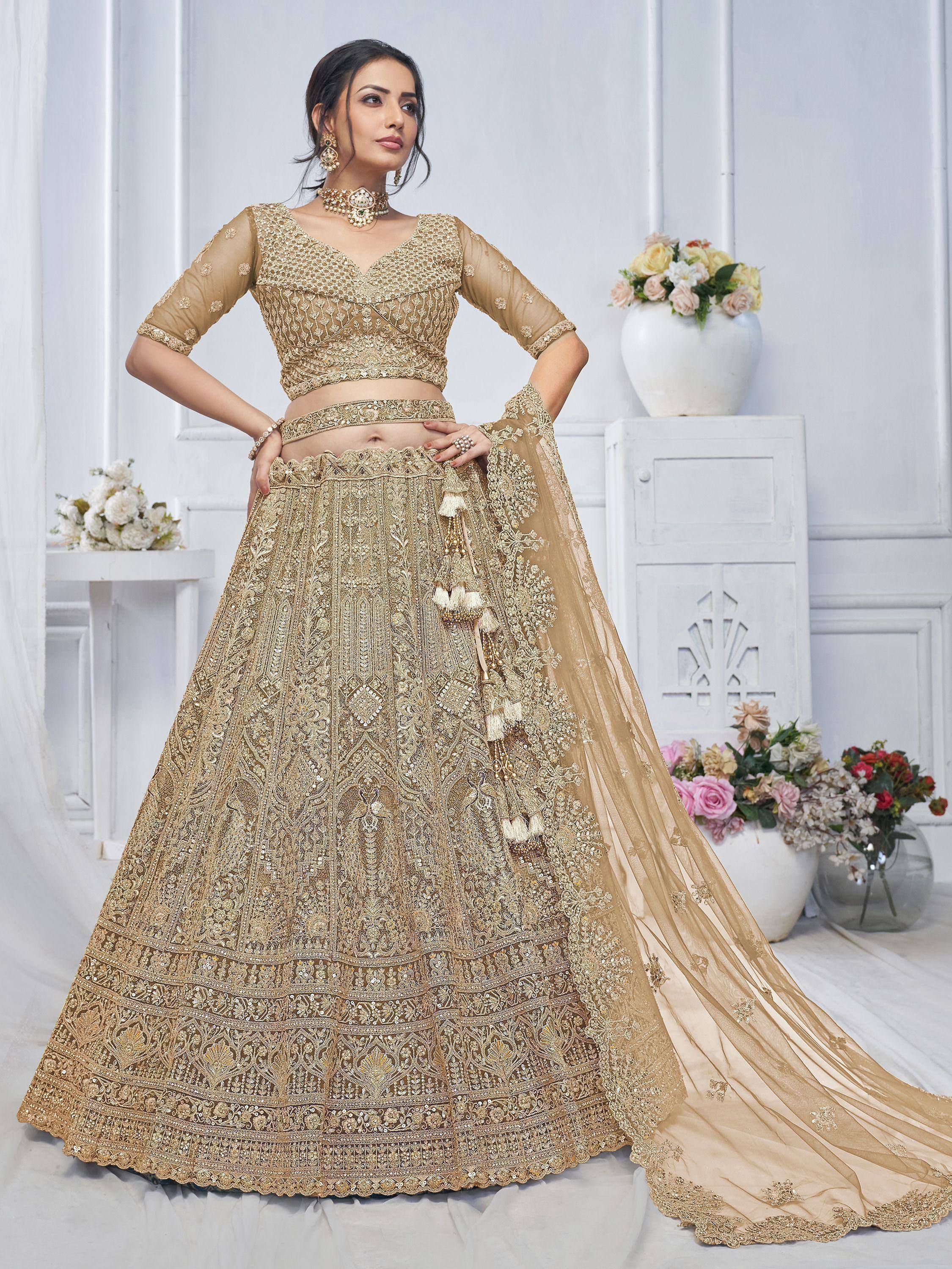 Golden embroidered lehenga choli with sheer dupatta, perfect for Indian weddings and festive occasions.