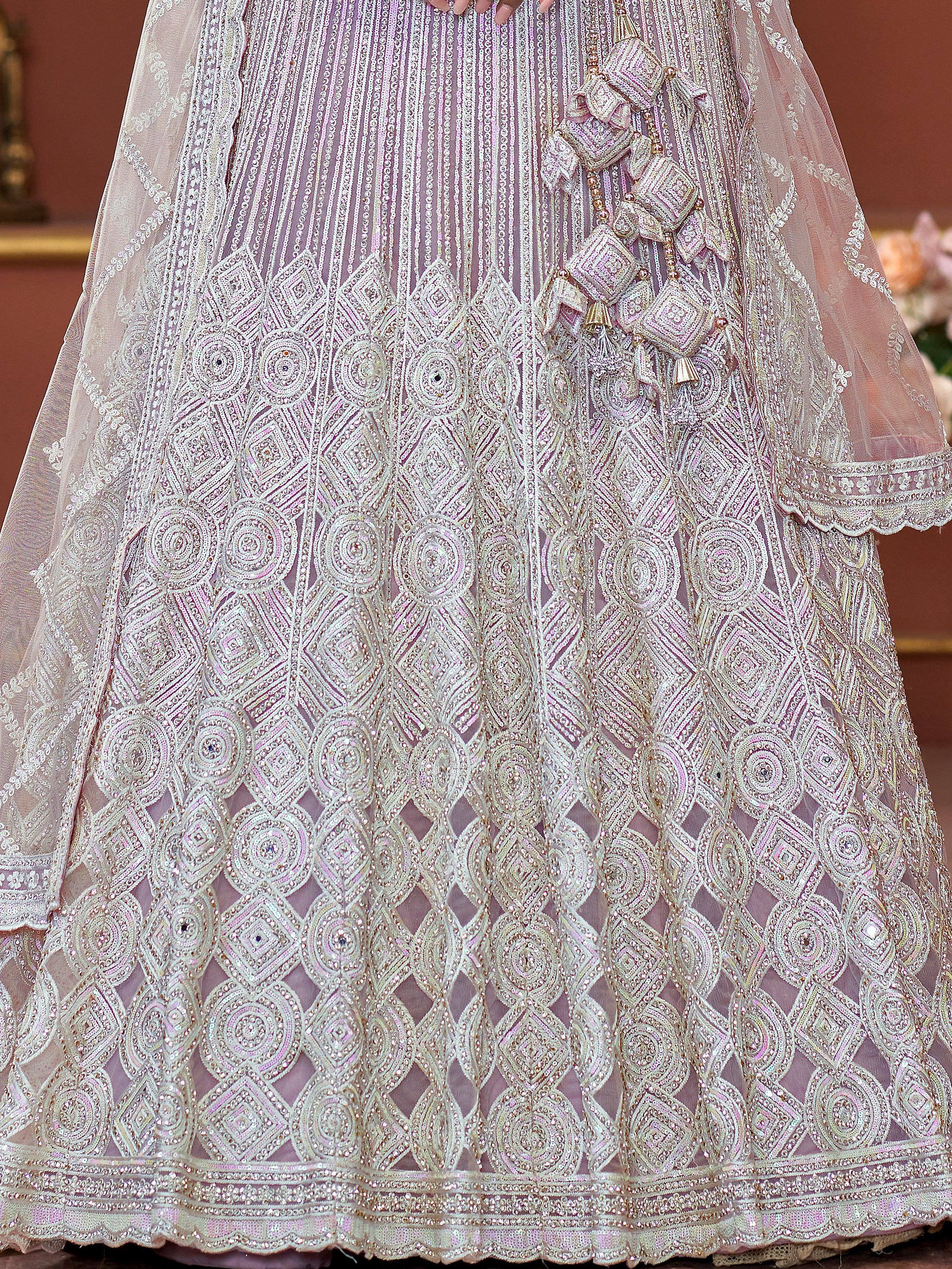 Elegant pink lehenga choli with intricate embroidery and sequin work, perfect for Indian weddings and festive occasions.