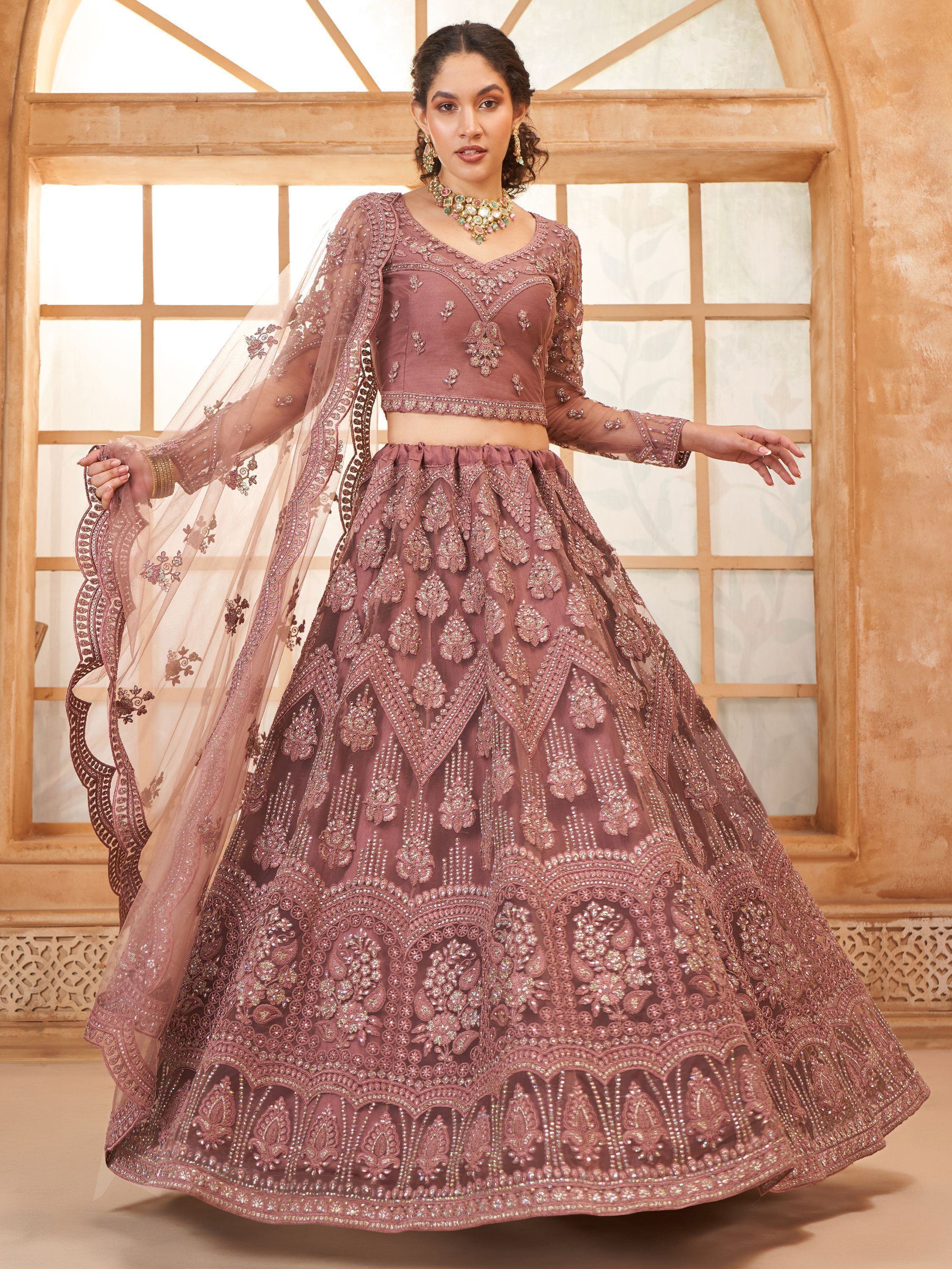 Elegant mauve designer lehenga choli with heavy embroidery and sheer dupatta, perfect for Indian weddings and festive occasions.
