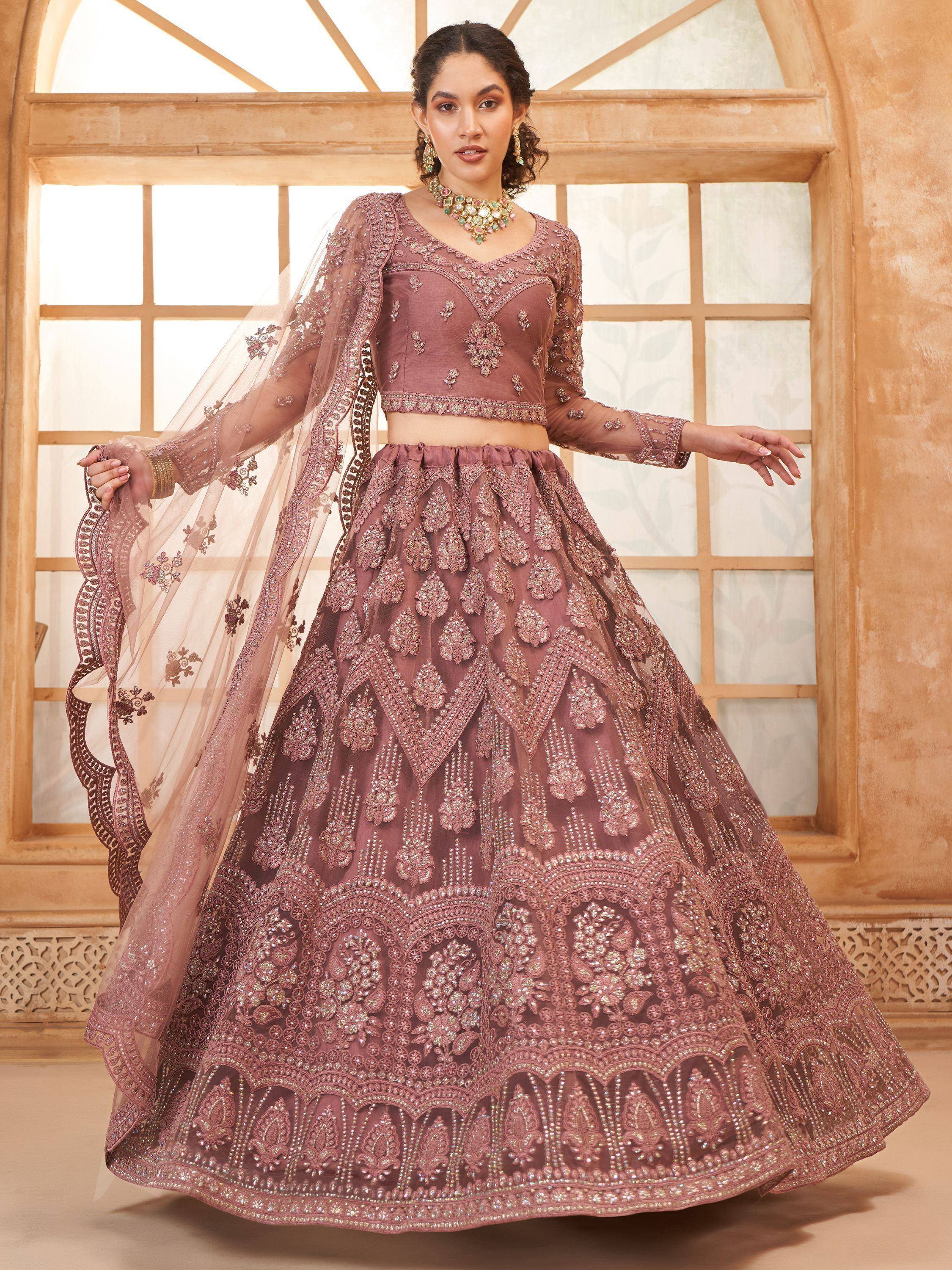 Elegant mauve designer lehenga choli with heavy embroidery and sheer dupatta, perfect for Indian weddings and festive occasions.