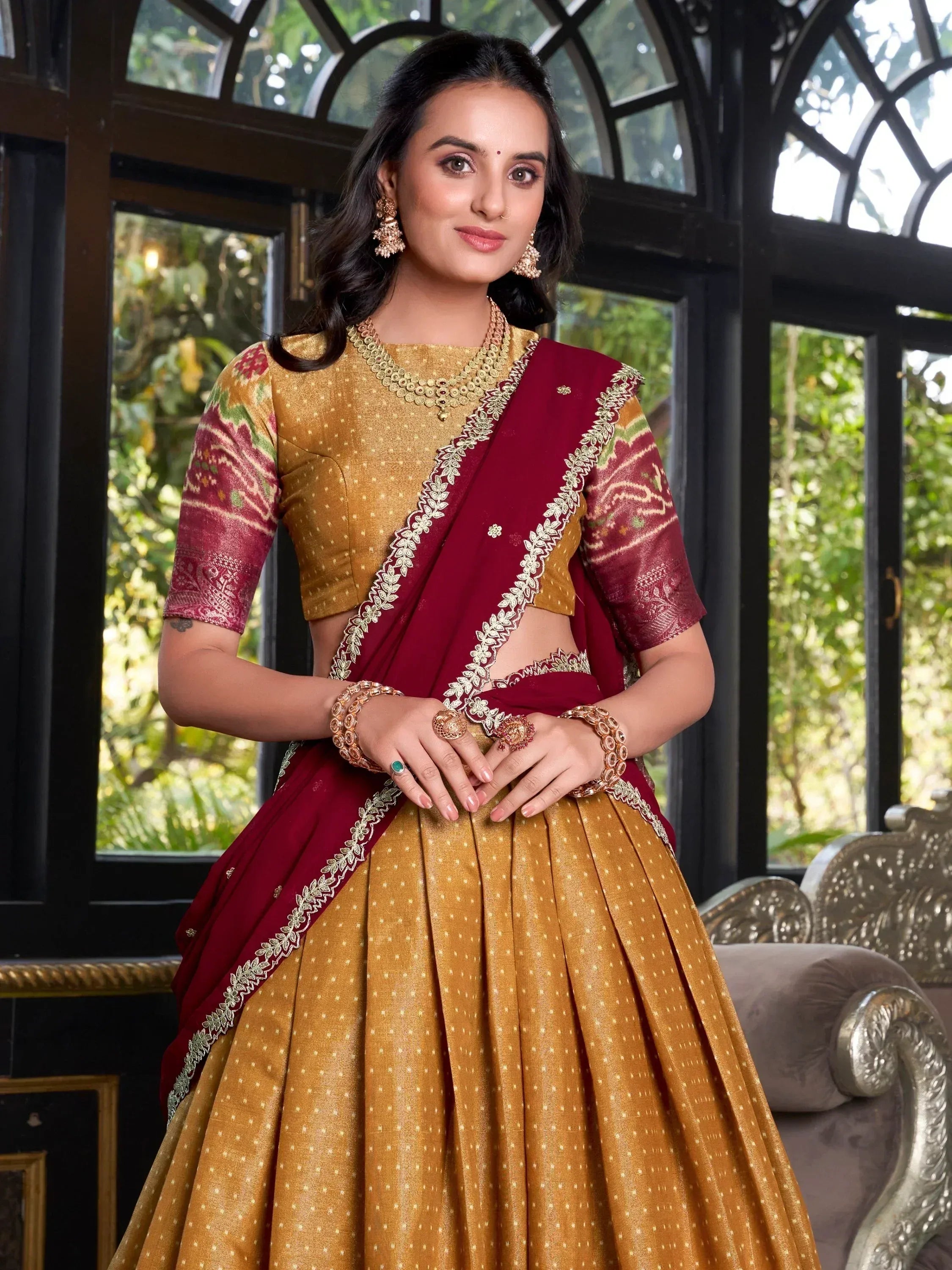Elegant maroon and gold lehenga choli with floral embroidery, perfect for Indian ethnic wear occasions.