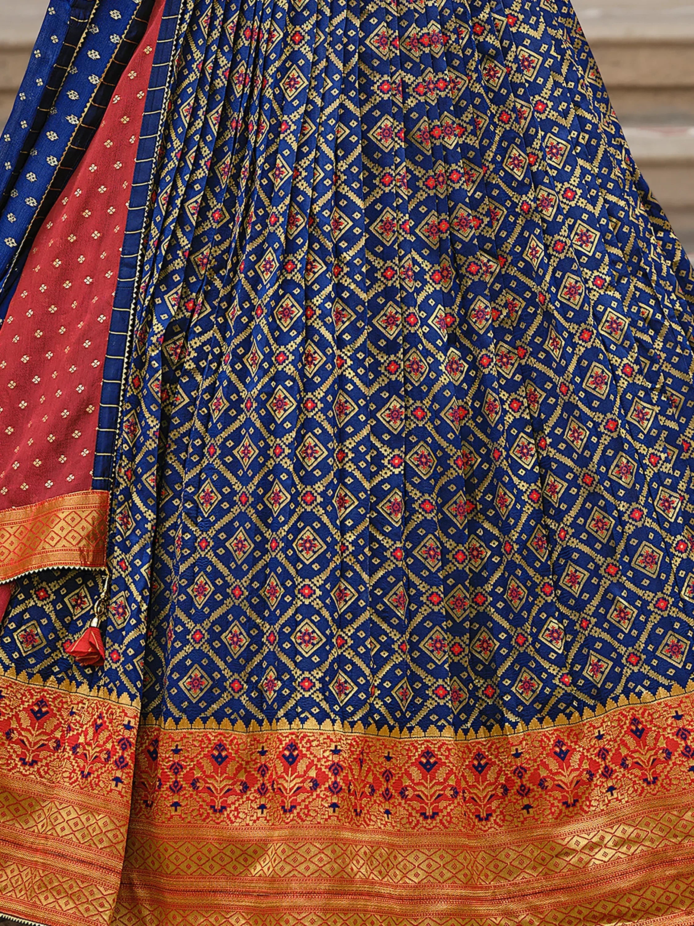 Blue and red ethnic lehenga with gold geometric patterns and embroidered border