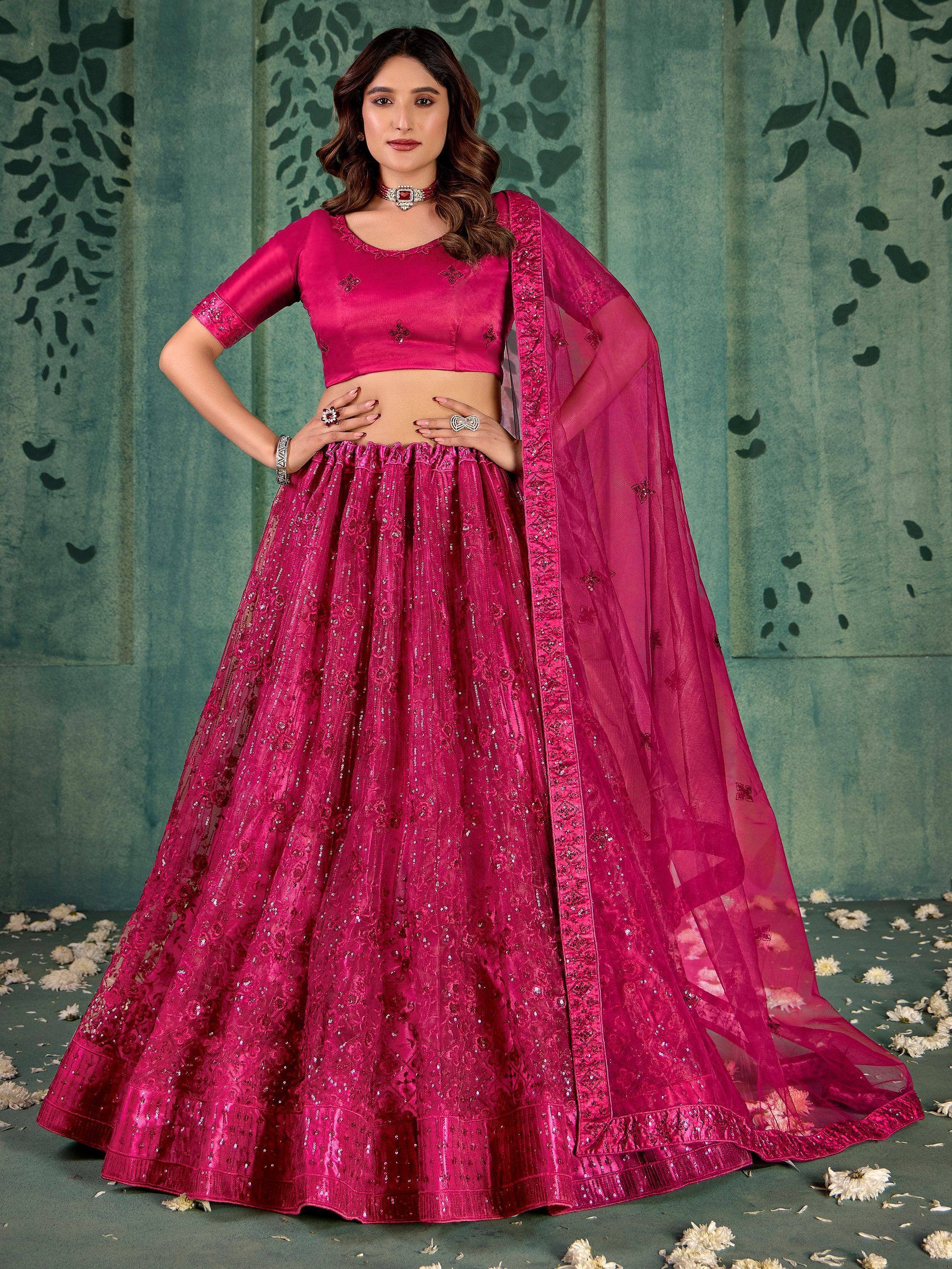 Fuchsia pink designer lehenga choli with sequin embroidery and sheer dupatta, perfect for Indian ethnic occasions.