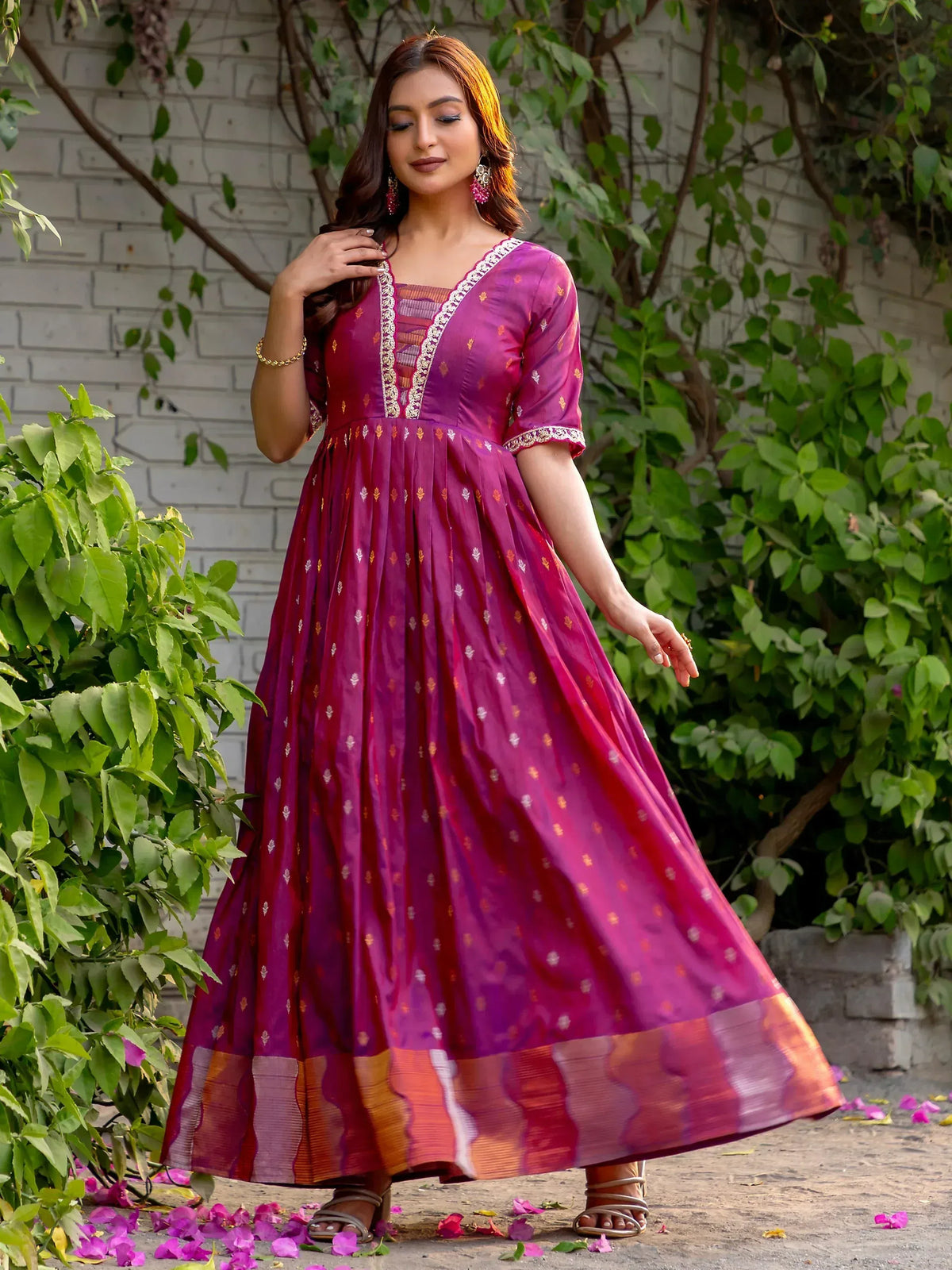 Elegant purple ethnic gown with gold embroidery and border, perfect for festive occasions