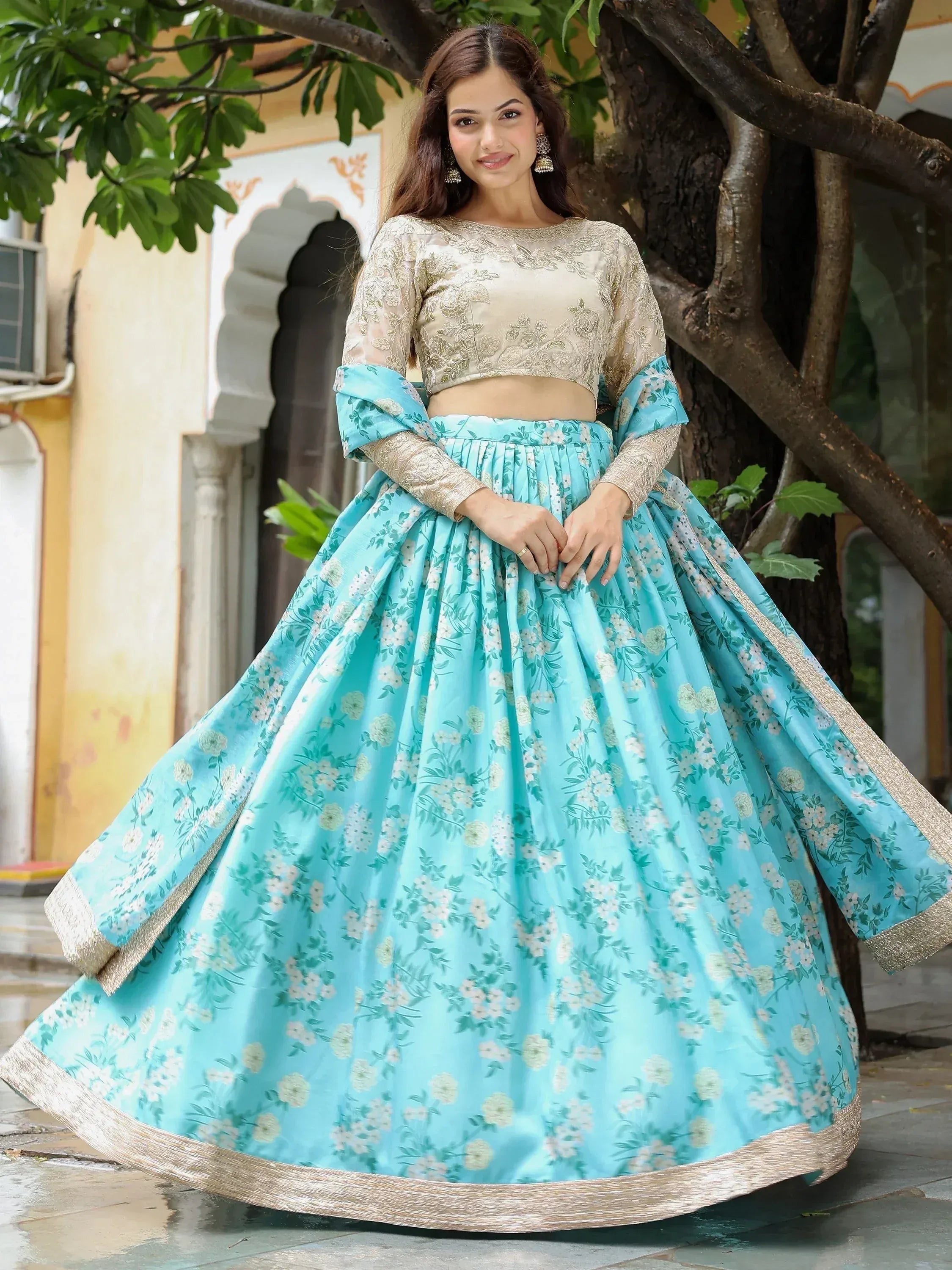 Woman in turquoise floral lehenga choli with gold embroidery, Indian ethnic wear