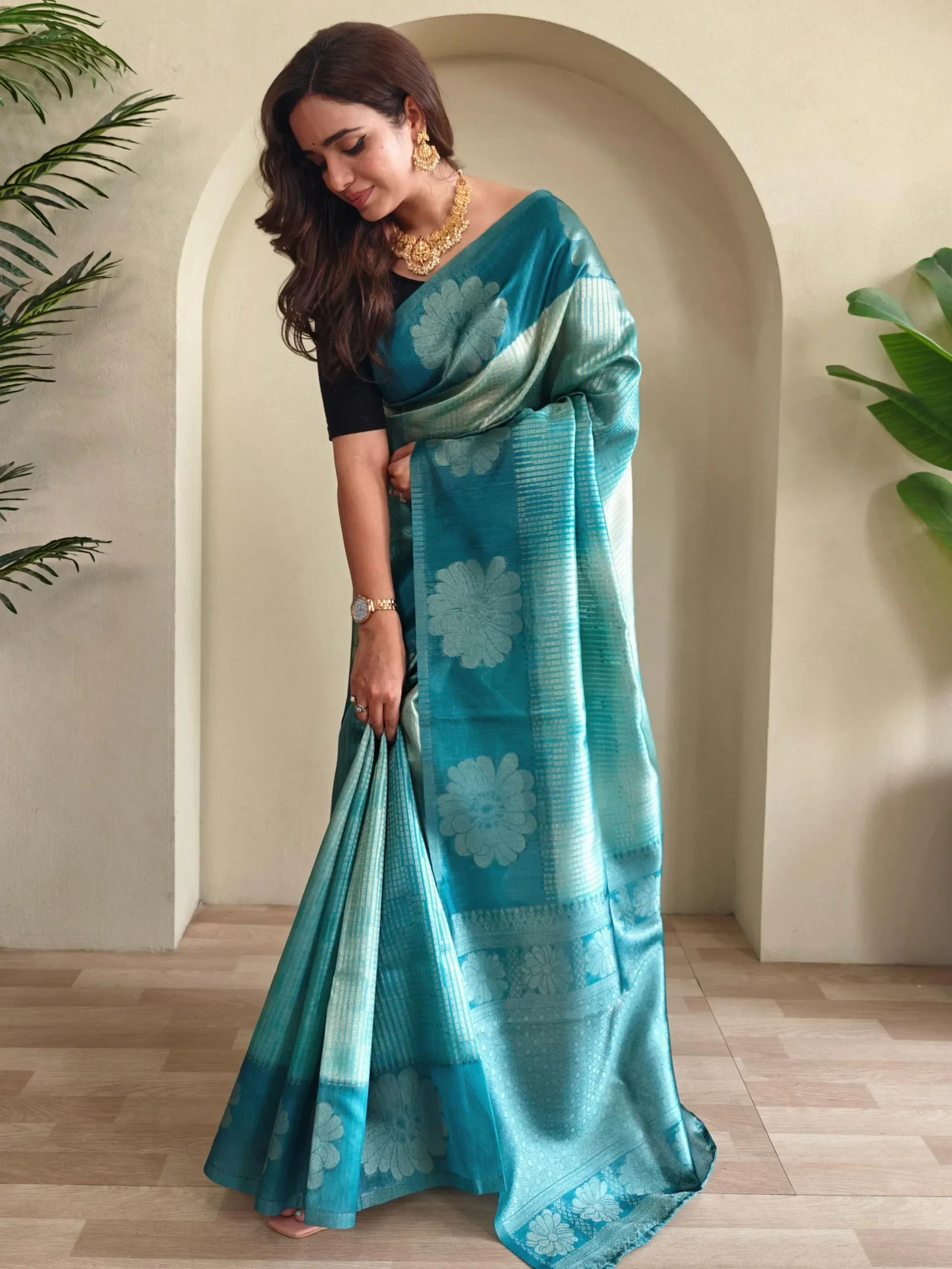 Teal floral designer saree with gold jewelry, perfect for Indian ethnic wear occasions