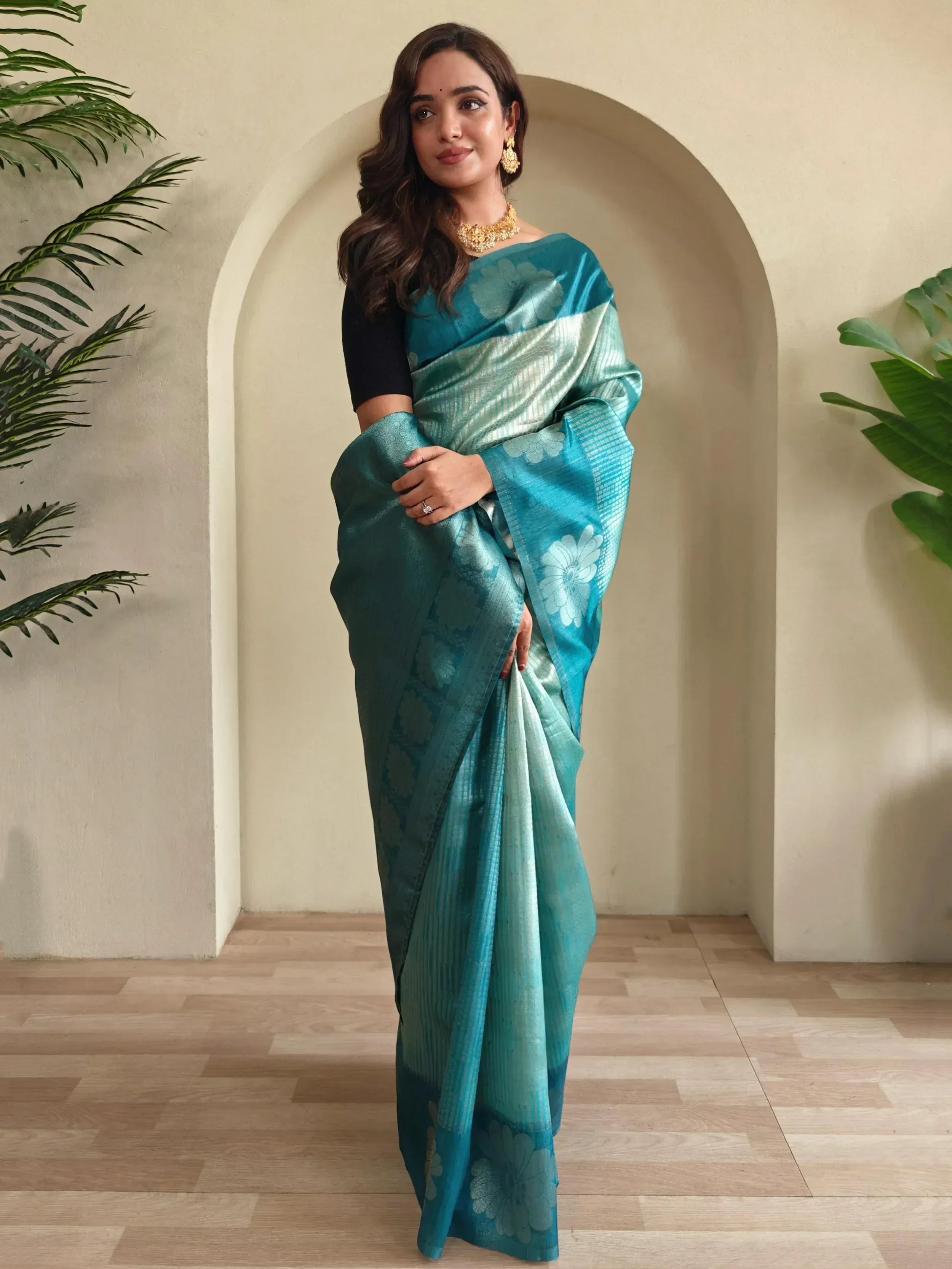 Teal floral saree with gold jewelry, styled for Indian ethnic wear occasions