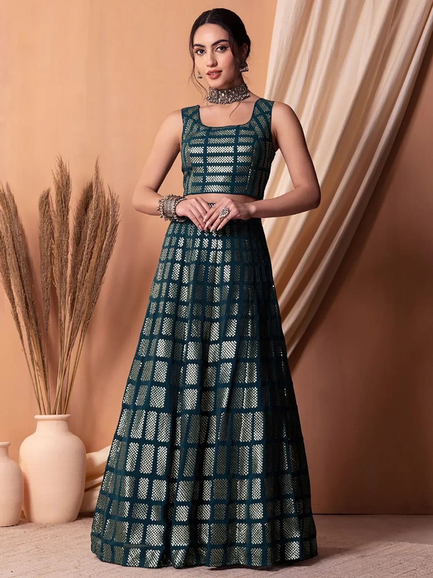 Teal green embroidered lehenga choli with geometric pattern, perfect for Indian ethnic wear occasions.