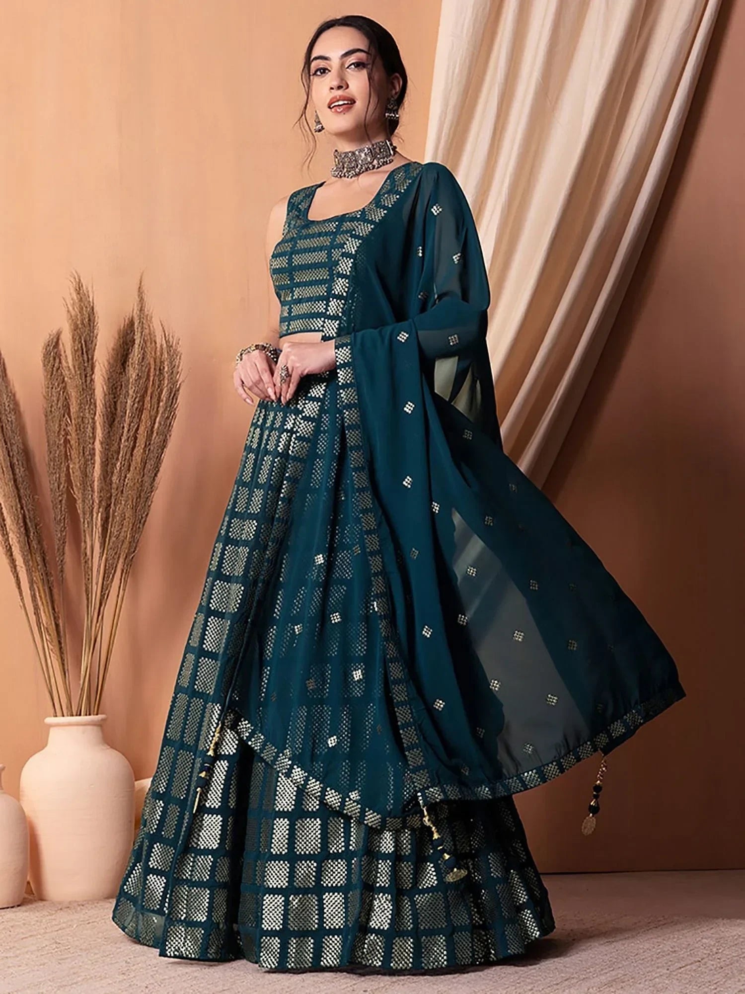 Teal designer lehenga choli with geometric mirror work and sheer dupatta, perfect for Indian ethnic occasions
