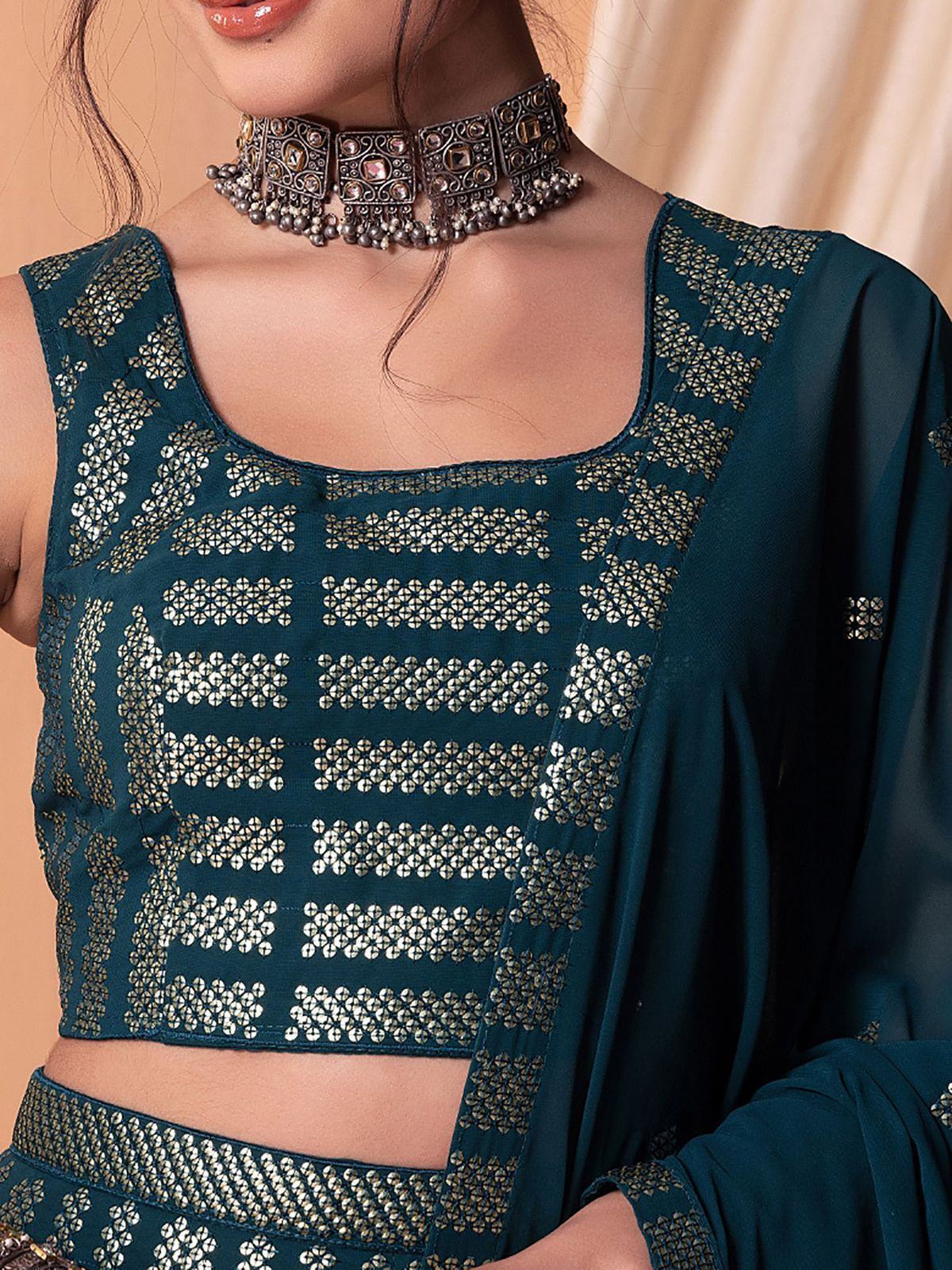 Teal ethnic crop top with gold mirror work, paired with matching dupatta and statement choker necklace