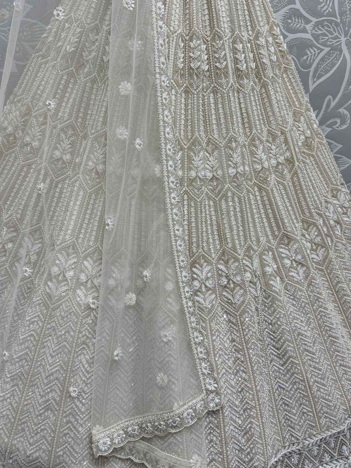 Elegant silver lehenga choli with intricate beadwork and floral embroidery, perfect for Indian weddings and festive occasions.