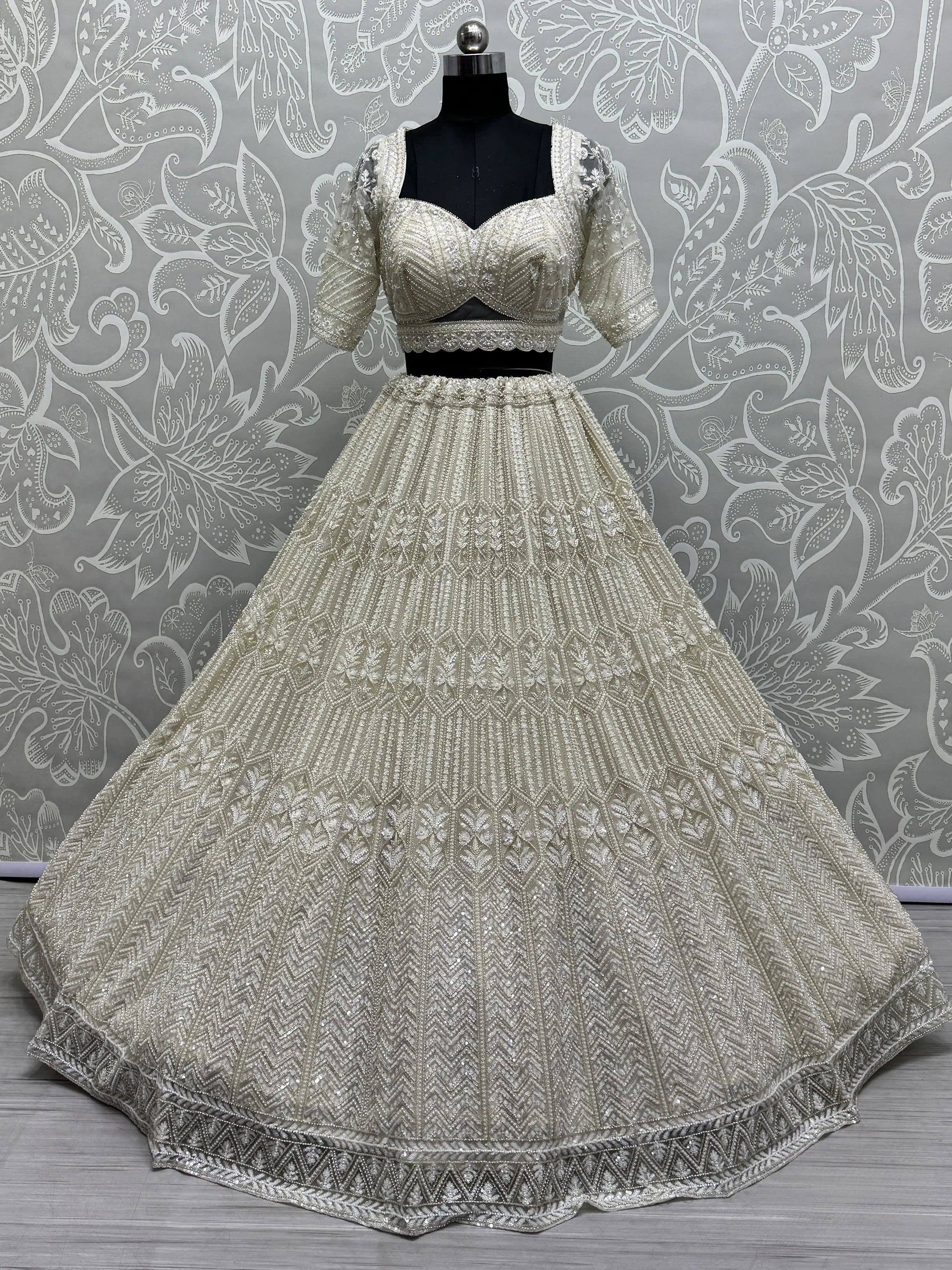 Elegant ivory lehenga choli with heavy embroidery, perfect for weddings and festive occasions.