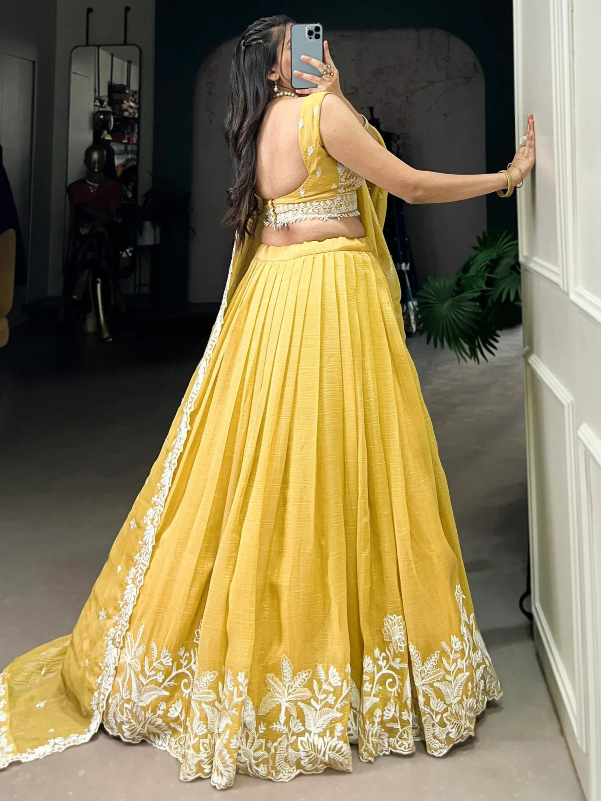 Yellow lehenga choli with white floral embroidery, backless blouse, pleated skirt, ethnic wear