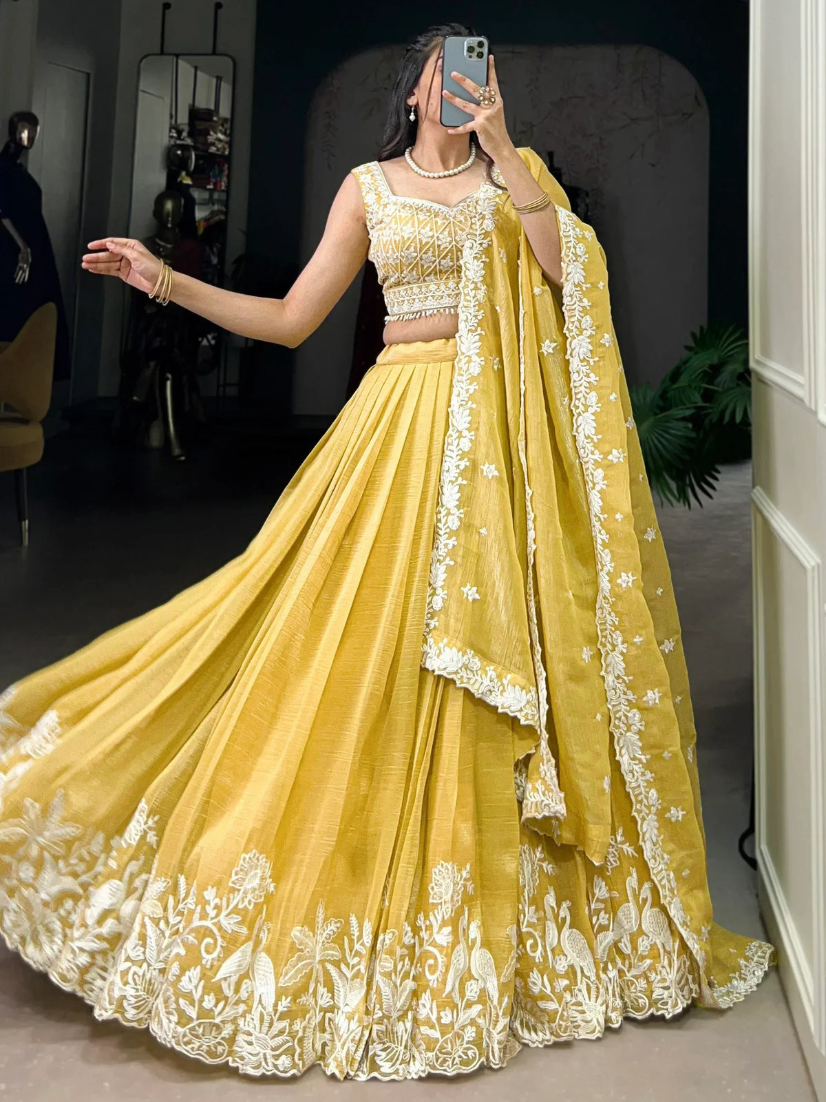 Yellow lehenga choli with white floral embroidery, perfect for Indian ethnic wear and festive occasions.