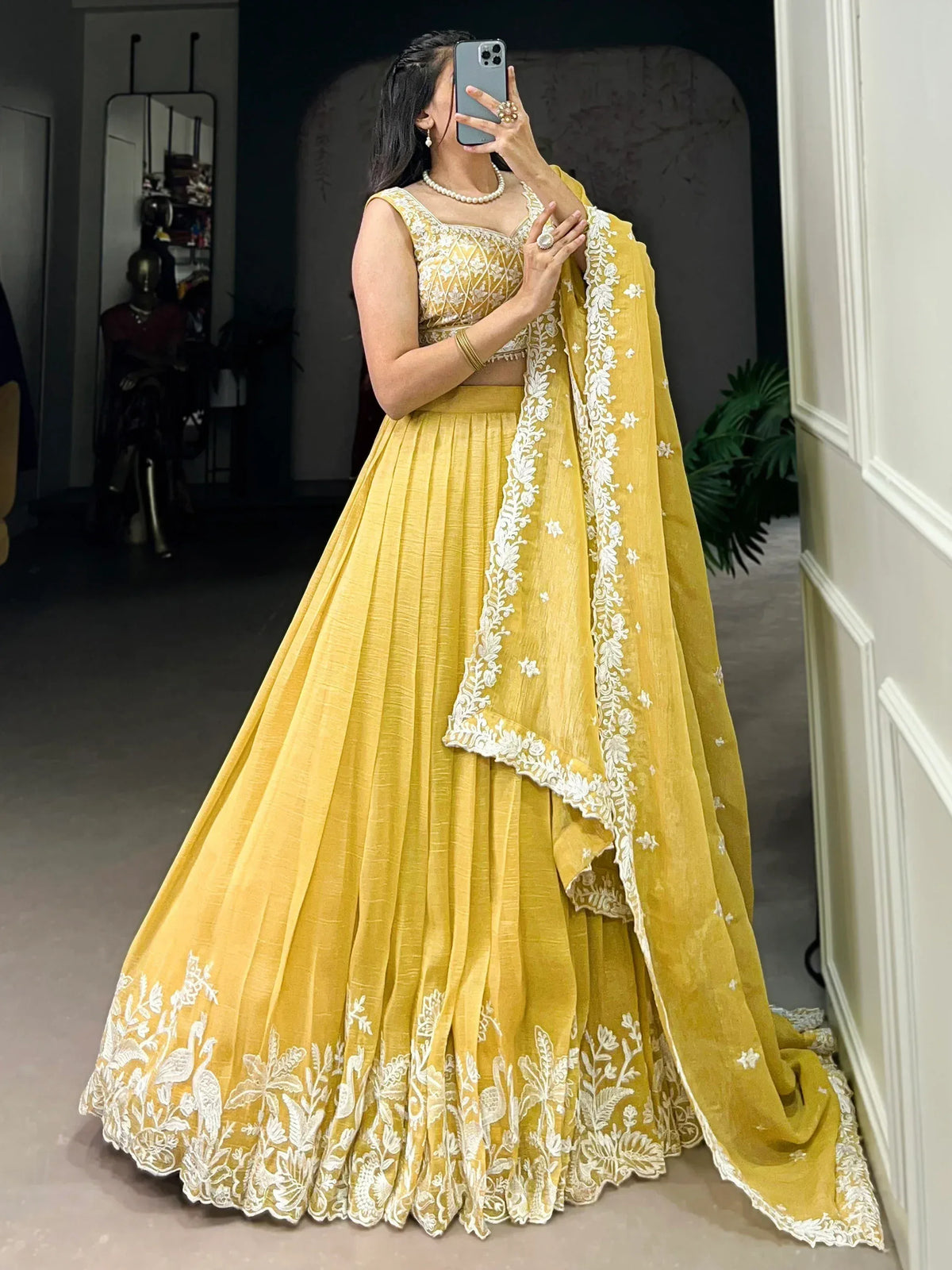 Yellow designer lehenga choli with white floral embroidery, perfect for weddings and festive occasions