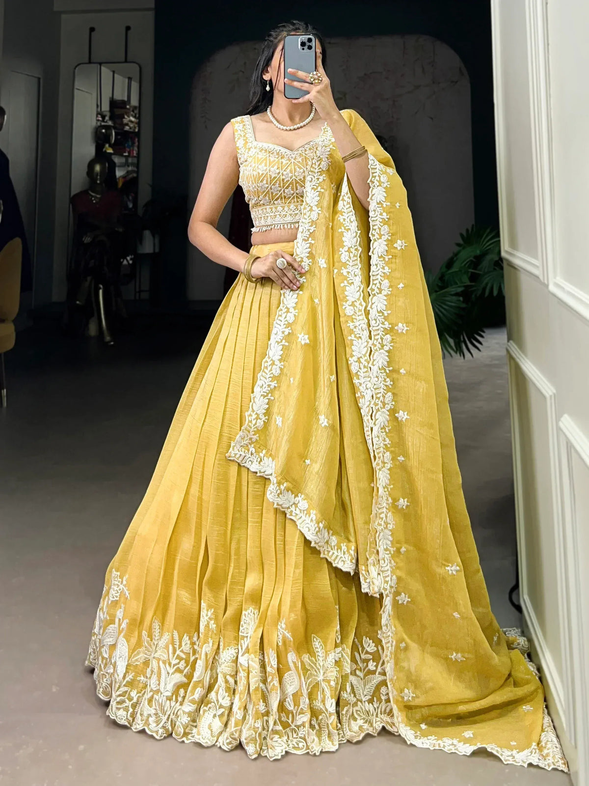 Yellow designer lehenga choli with white floral embroidery, perfect for Indian ethnic wear occasions