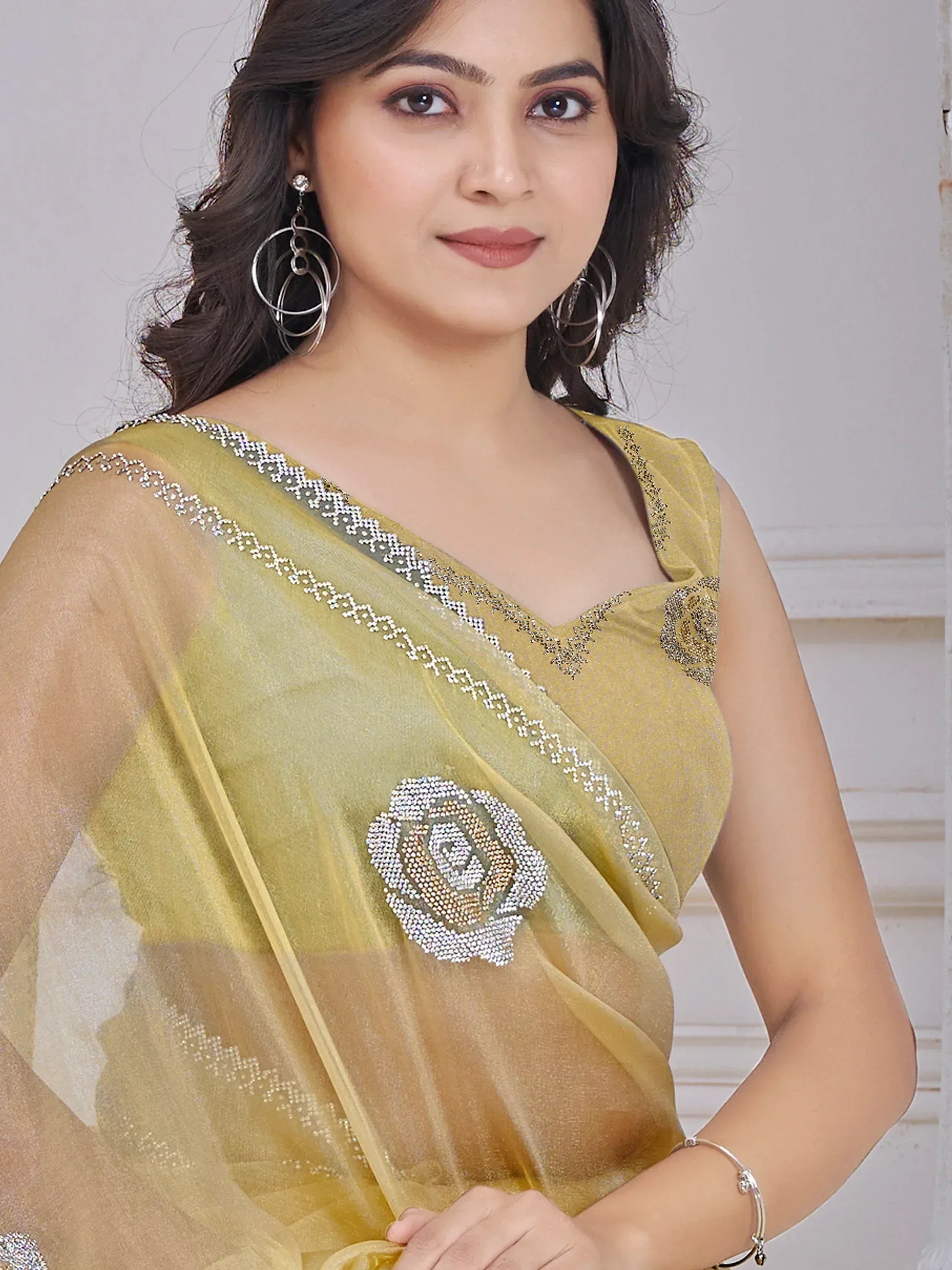 Woman in elegant mustard yellow saree with crystal rose embroidery and silver border, perfect for Indian ethnic occasions