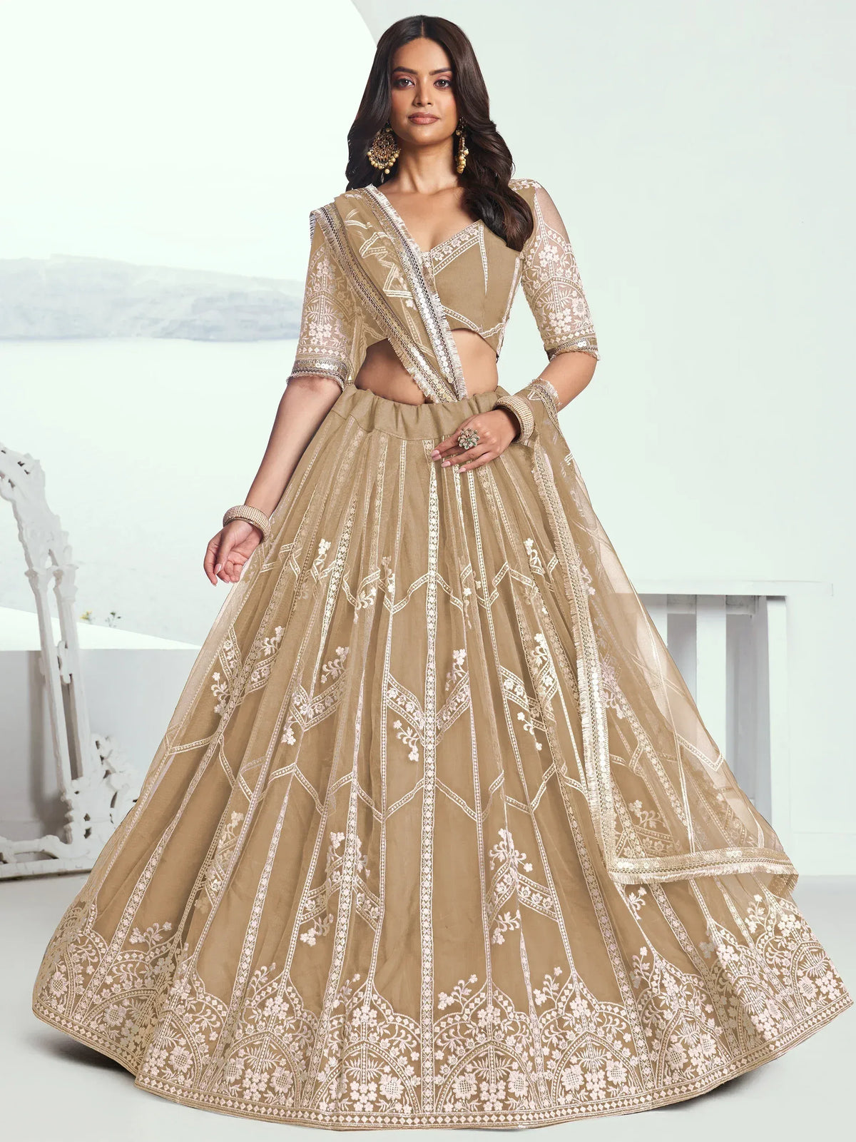 Beige embroidered lehenga choli with sheer dupatta, perfect for Indian weddings and festive occasions.