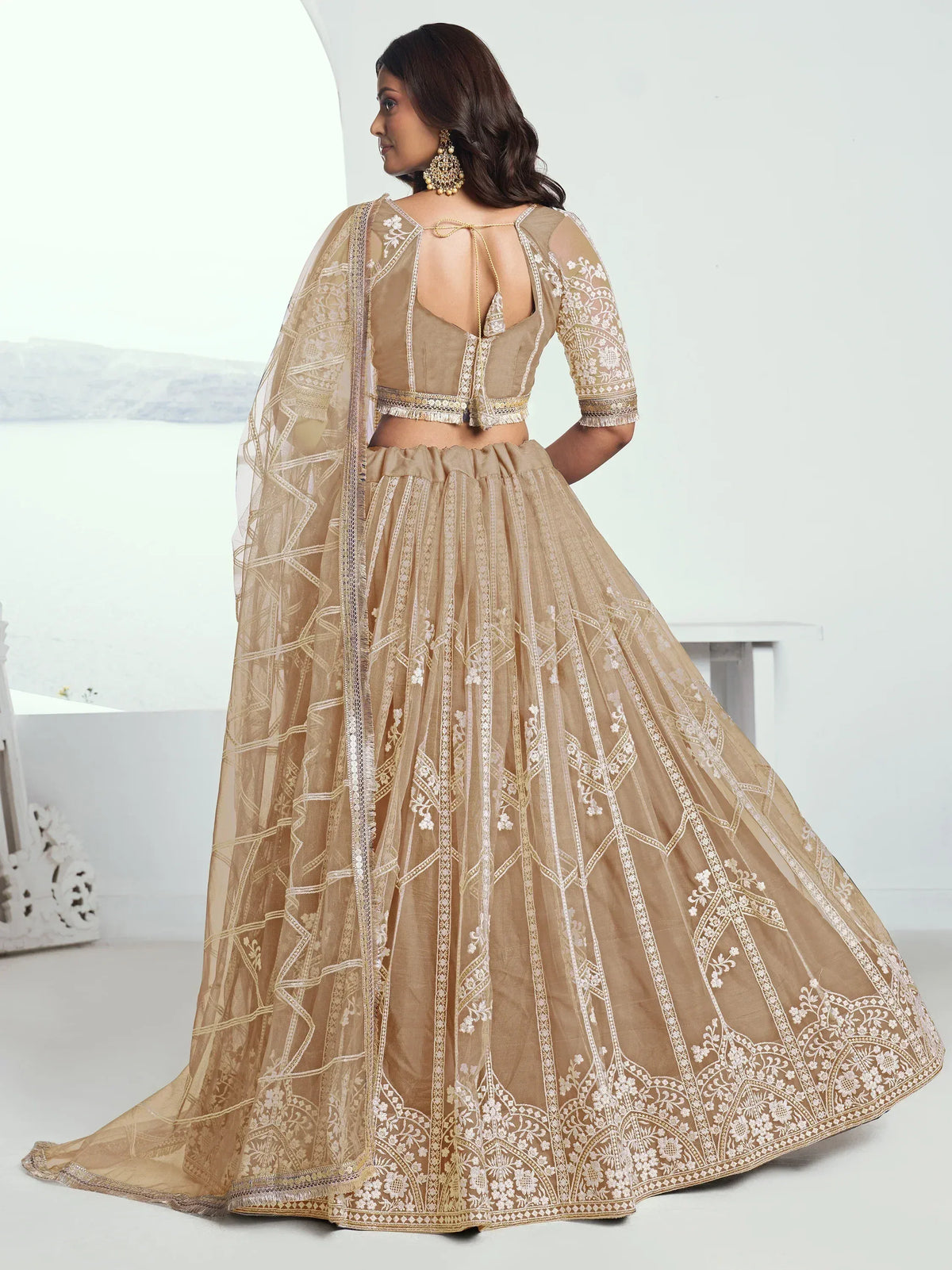 Beige embroidered lehenga choli with sheer dupatta, perfect for Indian weddings and festive occasions