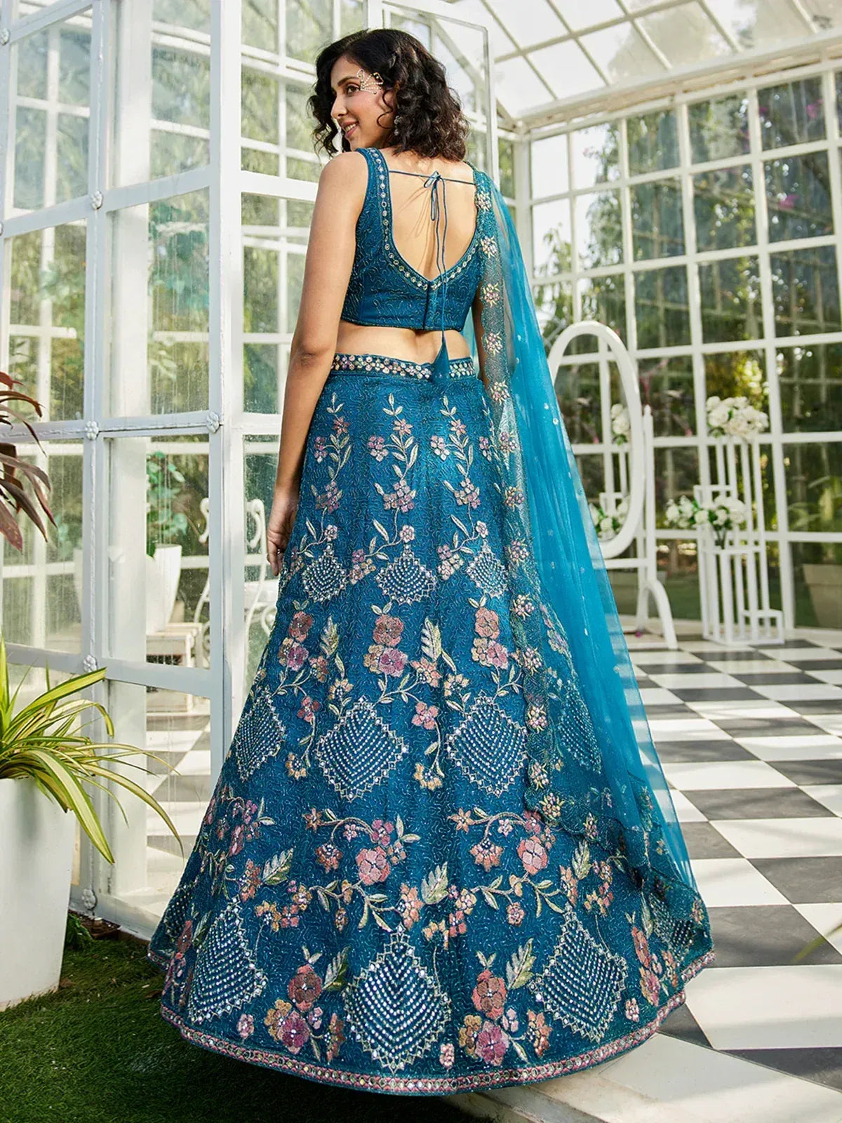 Teal floral embroidered lehenga choli with back tie blouse, perfect for Indian weddings and festive occasions.