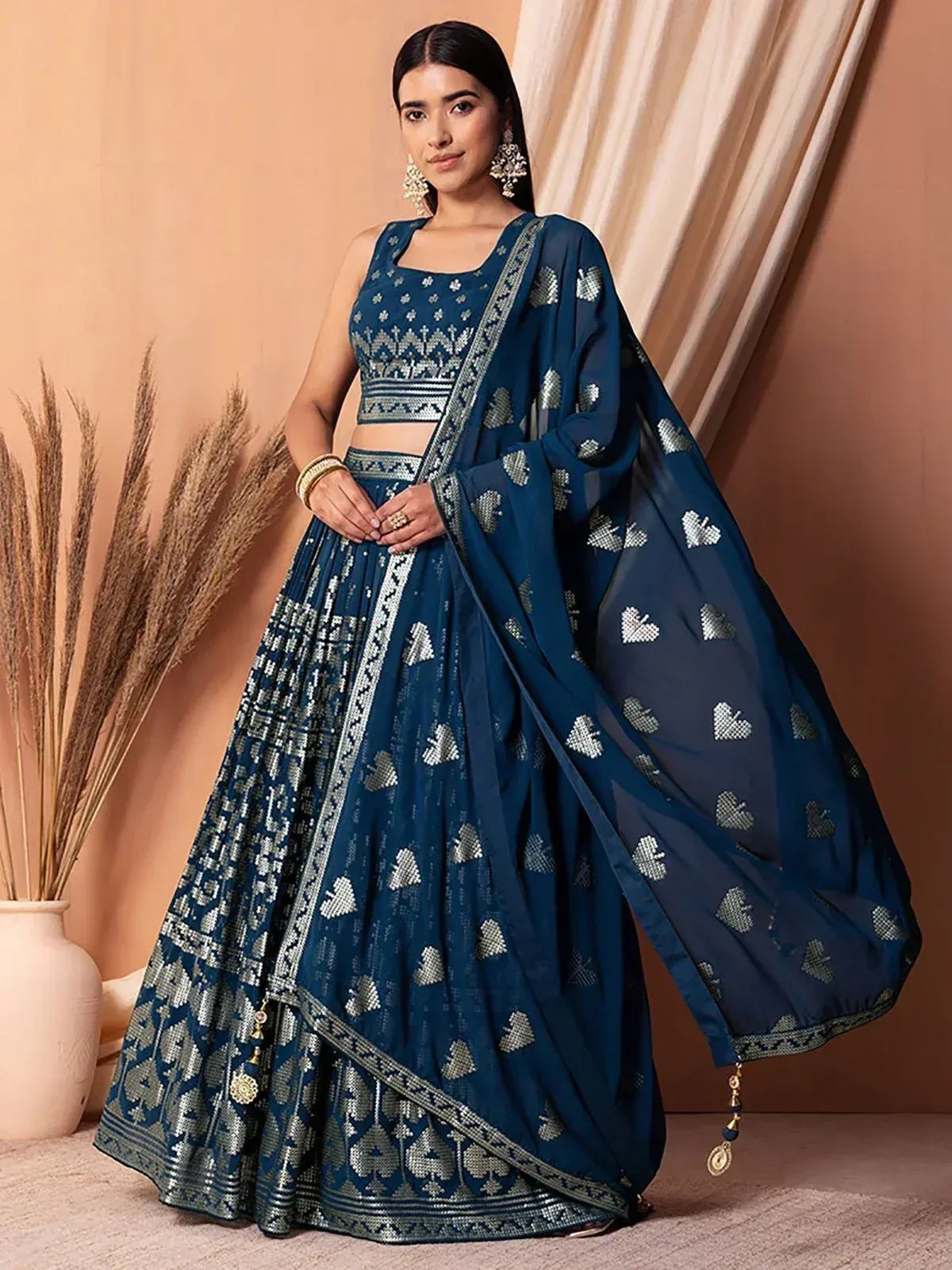 Blue designer lehenga choli with silver embroidery and heart motifs, perfect for Indian ethnic occasions