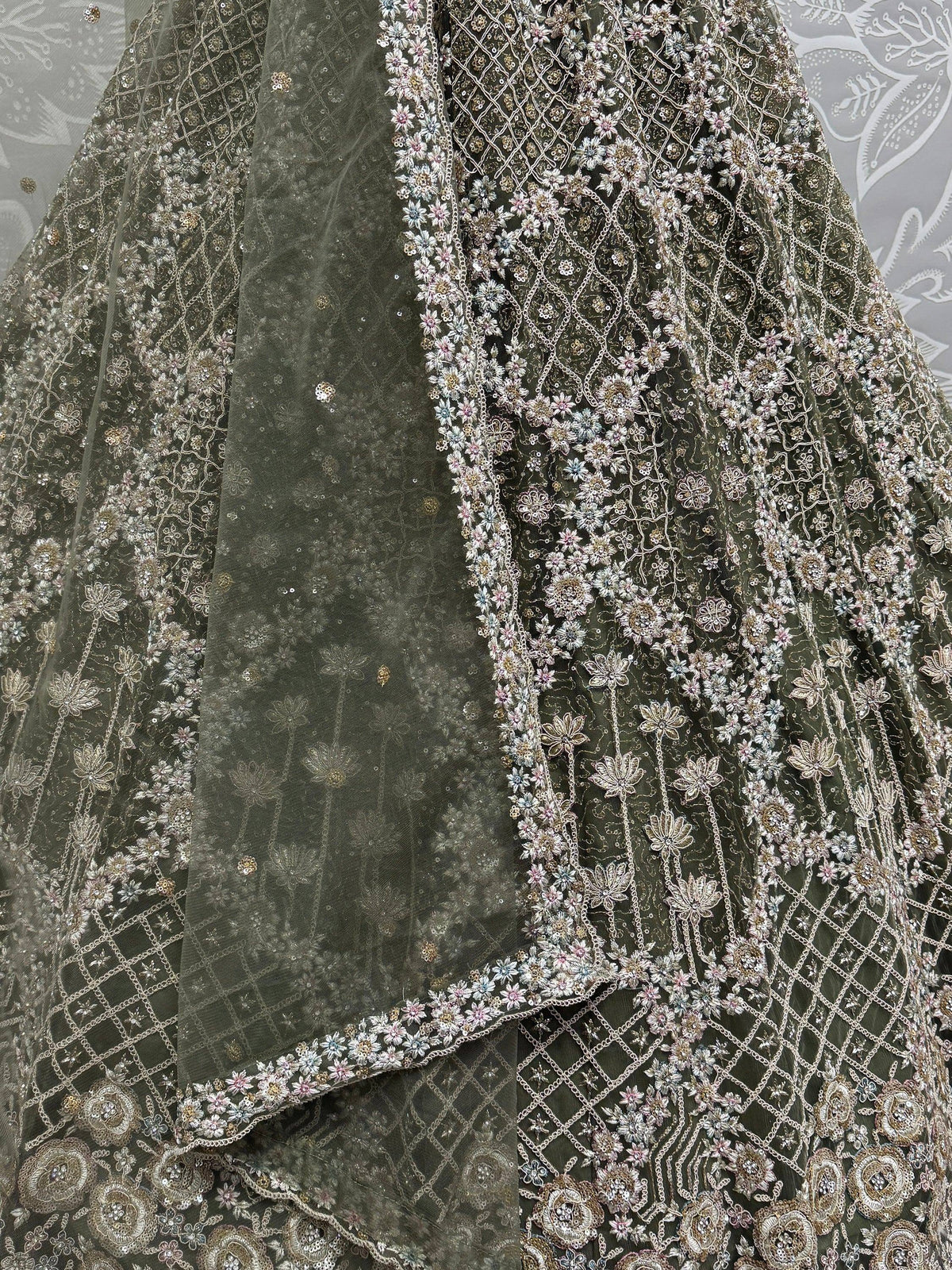 Olive green designer lehenga with intricate floral embroidery and sequin detailing, perfect for Indian ethnic wear.