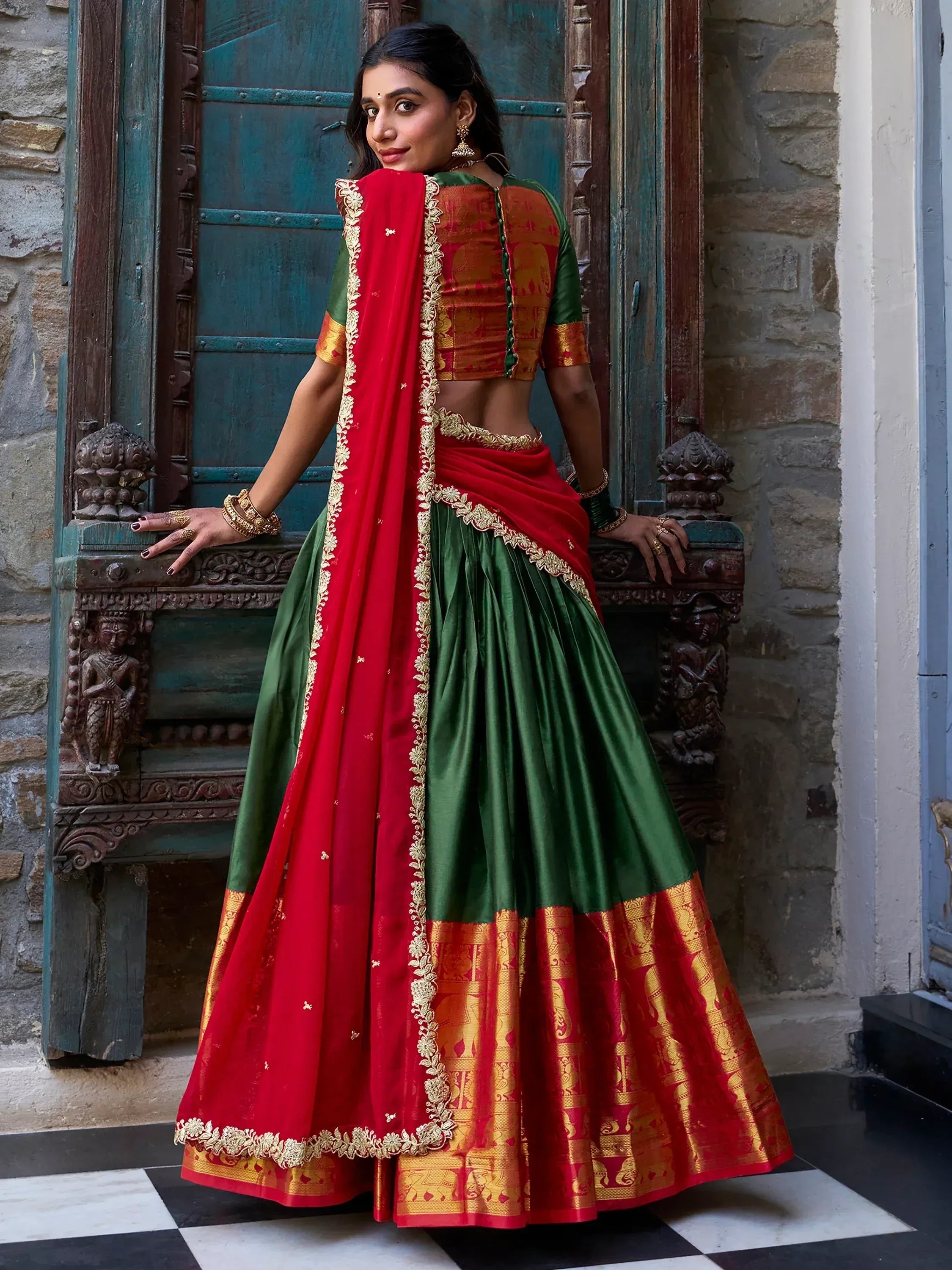 Red and green designer lehenga choli with gold embroidery, perfect for Indian ethnic wear occasions