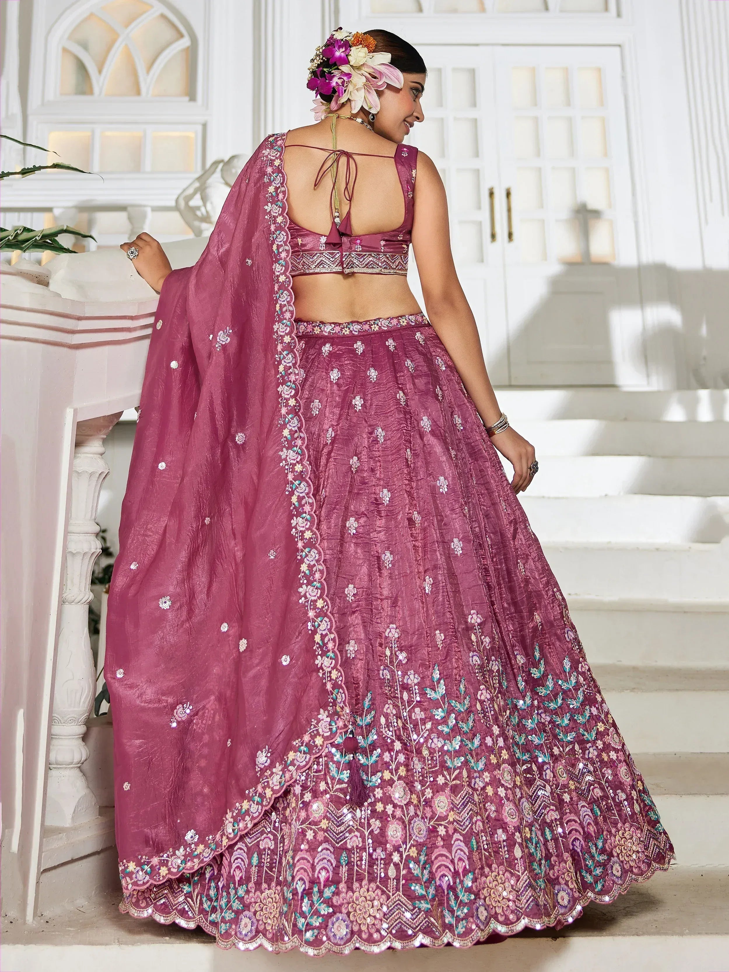 Pink embroidered lehenga choli with floral dupatta, perfect for Indian weddings and festive occasions.