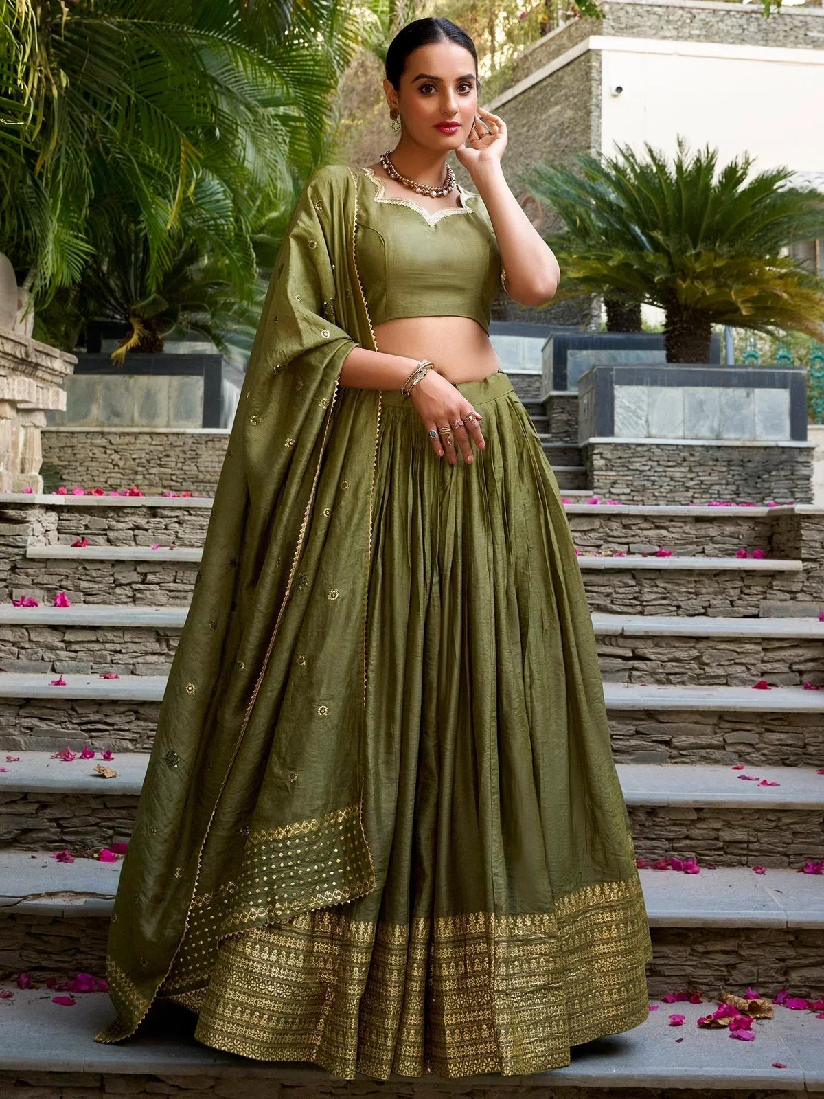Olive green designer lehenga choli with gold embroidery, perfect for Indian ethnic wear occasions.