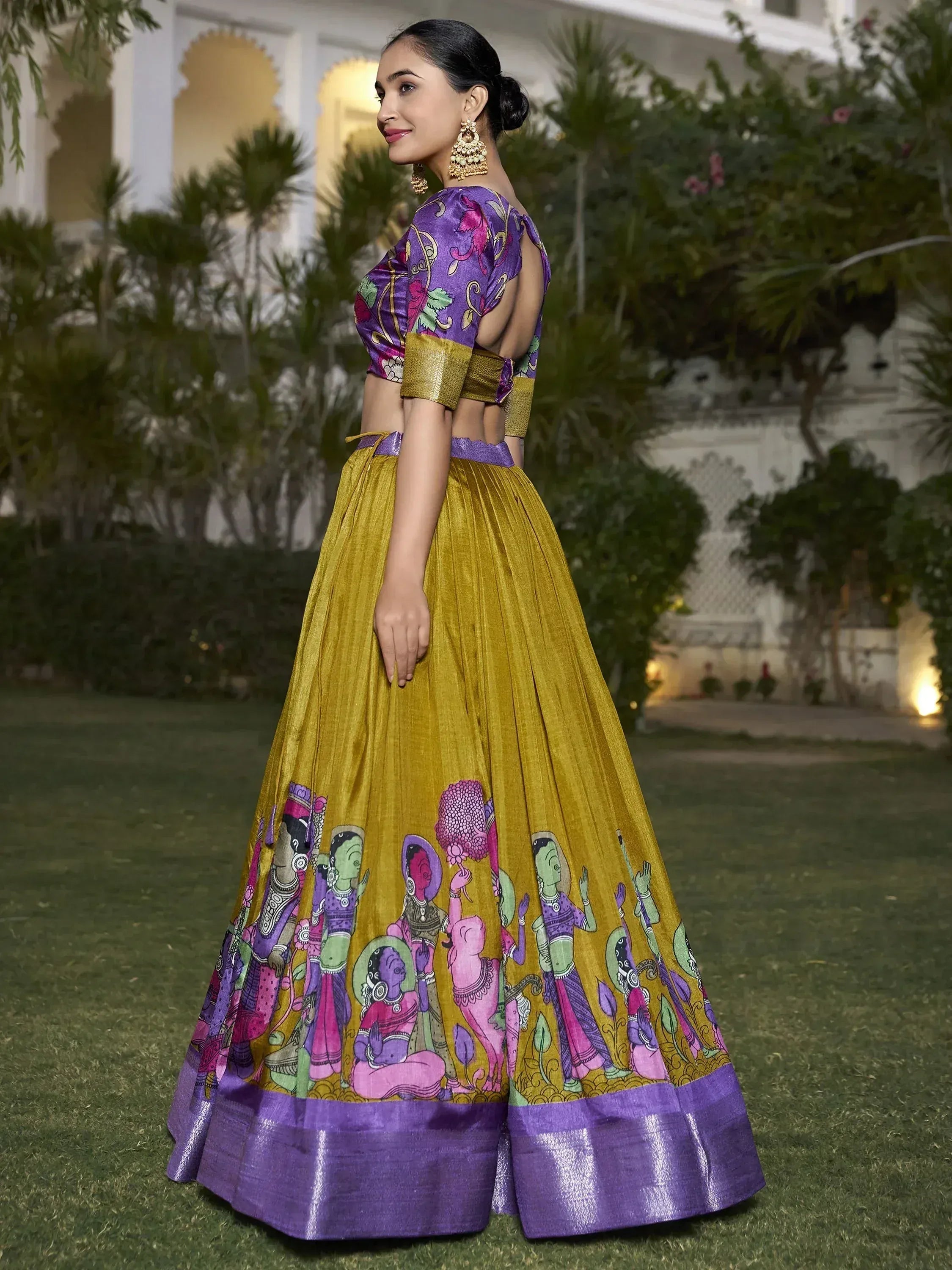 Purple and gold printed lehenga choli with ethnic artwork, perfect for Indian weddings and festive occasions.